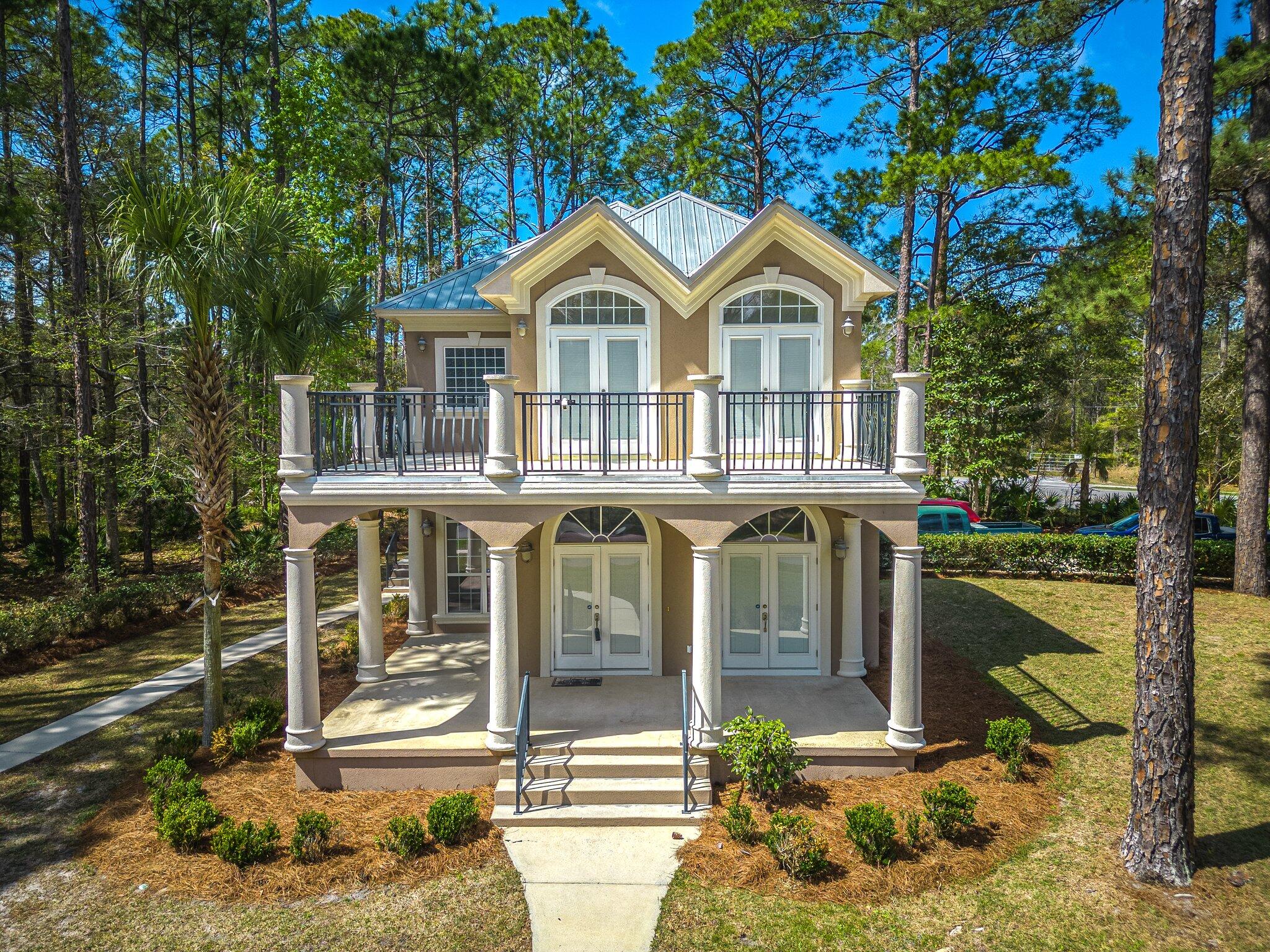 Want to live within 15 miles of the pristine white sand beaches along 30A. This is it. This home is being sold with the additional lot next door totaling over half an acre. Add a pool, mother in law suite, second home, storage building or just keep it for additional privacy. The custom built home is boasting with upgrades throughout. The balconies offer scenic views and the public boat launch is just a few miles down the road! Wood flooring, Corian counter tops, custom kitchen cabinets, and more. Two of the 3 bedrooms offer private en-suite bathrooms.  No HOA , underground utilities, Schedule a showing today.