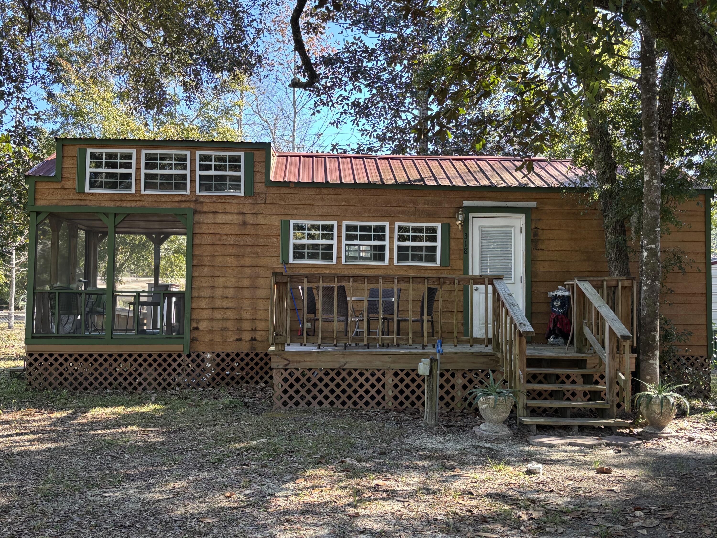 reat location in Howard Creek on a corner lot that has a mature and and well covered oak canopy for shade and year round comfort. A very clean and well maintained park model home that is mostly furnished, includes a loft, kitchen with range and refrigerator, living area, and screened in porch. Newly installed water filtration system in an enclosure for fresh clean water. A large newly constructed pole barn with a concrete pad with electric, water, and septic hookups as well as an additional RV hook up for a total of 2 on site. Large 20' X 12'storage shed with power that doubles as a laundry room is located at the rear corner and has a small air conditioner as well. This property has everything that an outdoor enthusiast could ask for and is clean as a whistle. Located a little over 1/2 mile from the newly renovated Gulf County lower landing, one has easy access to the Brothers and Apalachicola Rivers. Don't let this turn key recreational property pass you by! Dimensions were obtained from the Gulf County Property Appraiser's office, please verify if important.