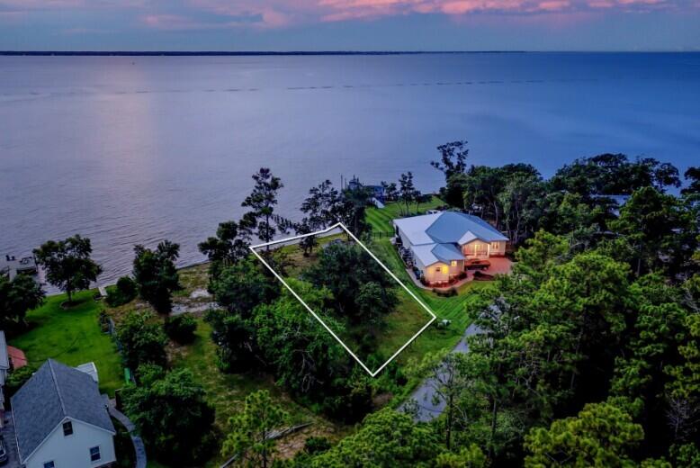 AMAZING VIEWS from one of Freeport's best-kept secrets-- waterfront lot on 115 feet nestled along the deep waters of the Choctawhatchee Bay on Red Barn Road. It is an exceptional site for boating enthusiasts and those who seek unobstructed views of pristine sunrises and sunsets over the water. This stunning parcel is a hidden gem among luxury homes, offering you the ideal canvas to create a waterfront retreat with endless boating possibilities.The seller has upgraded the retaining wall, ensuring lasting shoreline protection and adding significant value to the property. Red Barn Road is renowned for its peaceful atmosphere offering convenient access to the Emerald Coast beaches, and all that the Florida Panhandle has to offer. City Water and electric, City Sewer is available. . Robola Bluffs has recorded Restrictive Covenants but there is no HOA in effect at the present time - No HOA fees, and no build time.