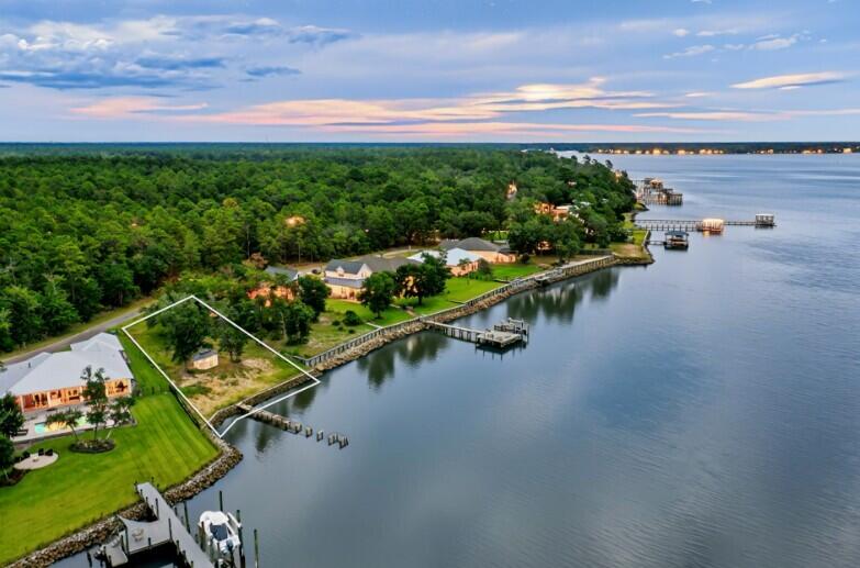 AMAZING VIEWS from one of Freeport's best-kept secrets-- waterfront lot on 115 feet nestled along the deep waters of the Choctawhatchee Bay on Red Barn Road. It is an exceptional site for boating enthusiasts and those who seek unobstructed views of pristine sunrises and sunsets over the water. This stunning parcel is a hidden gem among luxury homes, offering you the ideal canvas to create a waterfront retreat with endless boating possibilities.The seller has upgraded the retaining wall, ensuring lasting shoreline protection and adding significant value to the property. Red Barn Road is renowned for its peaceful atmosphere, offering convenient access to the Emerald Coast beaches and all that the Florida Panhandle has to offer. City Water and electric, City Sewer is available. . Robola Bluffs has recorded Restrictive Covenants but there is no HOA in effect at the present time - No HOA fees, and no build time.