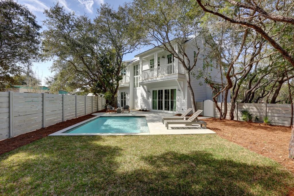 This custom cottage is a mastery of architecture and innovative design fashioned with clarity and intention. It is progressive and minimalistic, yet encompasses the essence of luxury living. 134 Blue Lake is a collaborative effort of design and construction; designed by Stephen Bricker and built by Onno Horn of Domicile. The final touches were tastefully designed by Domicile and Holly Shipman. Nestled in the signature dancing oaks of Blue Mountain Beach, just a block away from the Gulf, this retreat is both perspicacious and purposeful.The comfortable and peaceful outdoor space boasts a salt water pool, outdoor shower and a roomy pool deck all tucked away behind a pickled-pine privacy fence. The cantilever balconies were purposefully placed to leave room on the lot for the indigenous