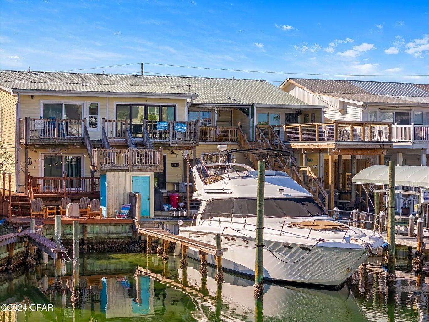 DEEP WATER, GULF ACCESS! PARK A 36+ FOOT BOAT ON YOUR PERSONAL DOCK! IF YOU PURCHASED A SIMILAR SLIP IN DESTIN, YOU WOULD PAY $200,000+. COMPLETELY REMODELED AND RENOVATED FROM THE STUDS TO THE FLOORS. You can be at Shell Island for an afternoon with friends in less than 10 minutes. Imagine waking up to amazing sunrises on your back porch, take a boat ride to Shell Island, meet with friends, and then take your boat back to your personal dock to enjoy a sunset! You can even take your fishing boat to the Gulf offshore for a day of snapper fishing. This is life on your terms in your new home! This 3 bedroom / 2 bathroom townhome has never been rented, but would be an awesome rental investment opportunity (the neighbor makes over $50,000 annually in rental income). This townhome is expansive and each floor feels like it's own lockout with supreme privacy. New countertops, new floors, new paint, new trim, everything is new - so expect to feel like you are in a newly constructed home. There is NO HOA except for a very small Holiday Isle annual assessment. There is gated beach access, the neighborhood is golf cart friendly, and Holiday Isle is quaint with a friendly, neighborly vibe. The downstairs bunk room closet could be converted back to a bathroom (plumbing in walls), and the attic space could be converted to loft space. The top deck could be extended to the seawall. A really unique feature of this property is that you can utilize a water taxi to take you and your family and friends to all the local harbor restaurants. Holiday Isle entertainment and amenities are world-class. World-class restaurants, shopping, and access to the best beaches, you are sure to be pleased with your new home! Get ready to experience life to the fullest with this deep water townhome located in prestigious Holiday Isle. Schedule your showing today.