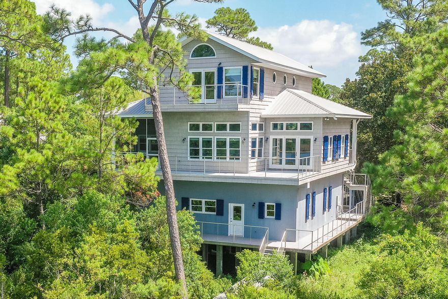 Rare opportunity to own a home on secluded Oyster Lake Drive! This 3 bedroom 3 full bath home with three car garage sits on tranquil Oyster Lake and offers unobstructed forever views of lake and Gulf. The main level features an open concept kitchen/dining and living area. The open expanse has 12 ft ceilings, pickled wood walls and ceilings and contains a gas fireplace. Enjoy spectacular sunsets while relaxing in this space or on the large screened porch or spacious deck with stainless steel cable railings. This level has two large bedrooms, full bath, large laundry and walk in pantry. Elevator or wide stair way leads you to the master suite with a walk in cedar closet with built-ins, a full bath with garden tub and large shower and a handy wet bar.