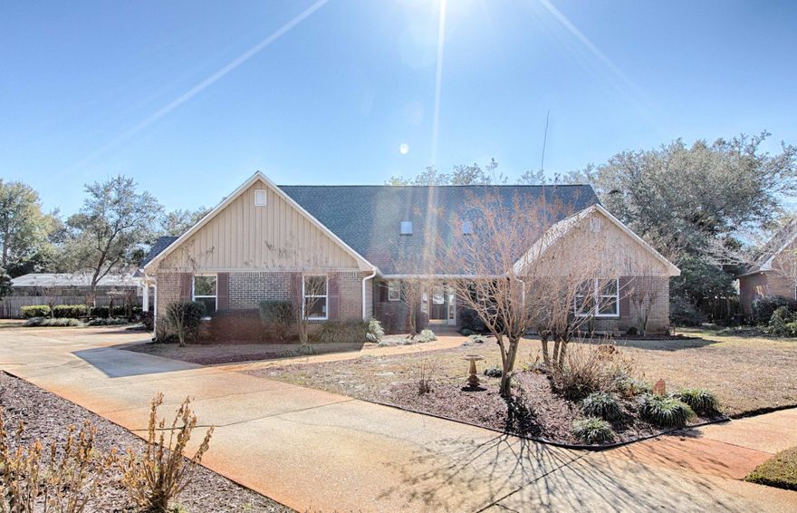 Private setting with huge manicured yard at the end of a cul-de-sac. Front covered rocking chair porch welcomes you to the stately foyer and two story vaulted fireside family room. Beautiful travertine flooring throughout. Big family gatherings will enjoy the banquet sized formal dining room or turn this into your second living area. Recently updated kitchen with stainless appliances, granite tops and painted wood cabinets. Covered porch off kitchen/breakfast perfect for grilling. All 4 bedrooms are huge. Master and guest bedroom on first floor plus a second Master and guest suite on second floor. All bathrooms have been updated with rich wood cabinets. Stunning chandeliers throughout. Laundry room and second laundry hook up in mud room off garage. New roof installed in December 2017!