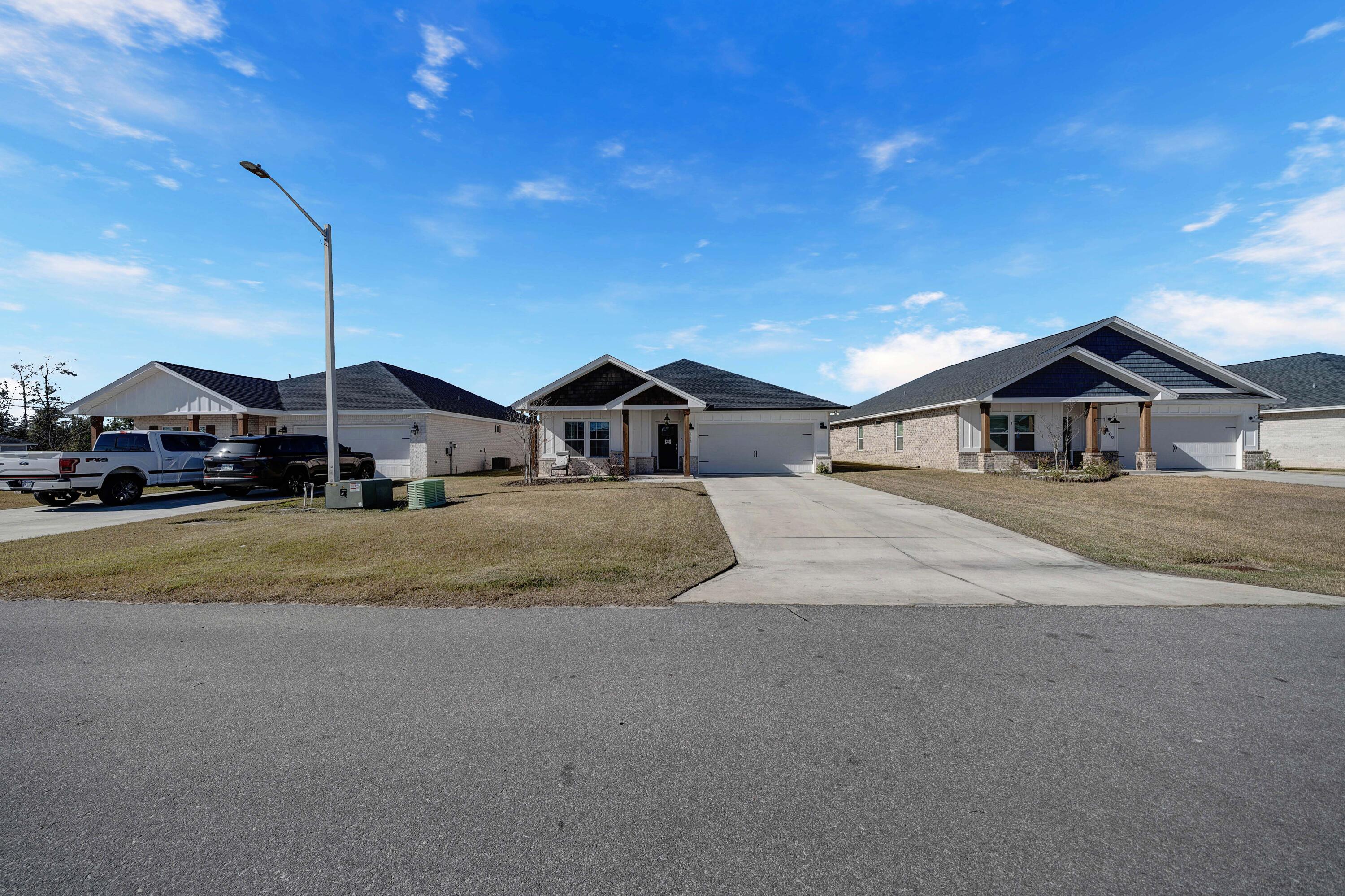 This recently constructed home, built in 2022, is situated in a fantastic cul-de-sac location, being the second house on the left. It exudes coastal charm with its whitewashed brick exterior. The property features a spacious open floor plan, providing privacy in the master bedroom, which is separated from the other two bedrooms. It includes 3 bedrooms and 2 bathrooms. Whether you're hosting family gatherings or enjoying a quiet evening at home, this property offers a perfect blend of comfort and style. The living area greets you with abundant natural light, showcasing the stylish finishes and contemporary design, complete with a tray ceiling. The kitchen, a true centerpiece, is equipped with stainless steel appliances and a large island that doubles as a breakfast bar.