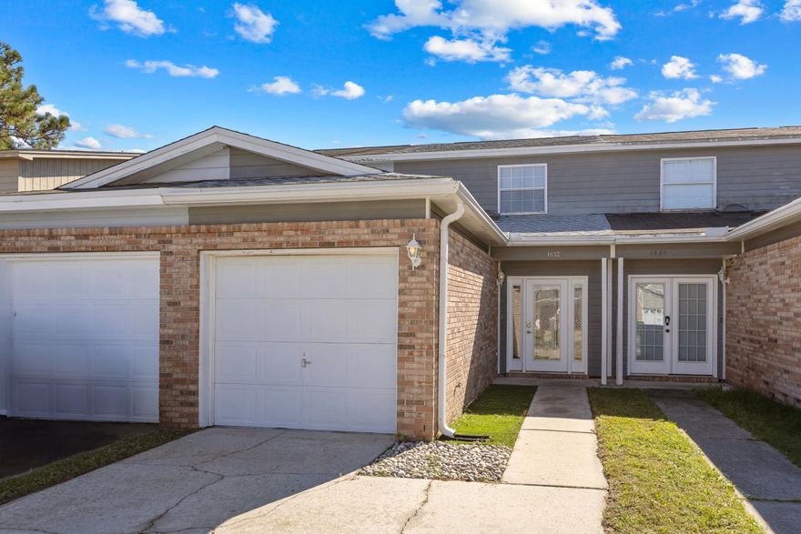 Welcome to 1832 Whispering Oaks Lane, a beautifully updated town home in the heart of Fort Walton Beach just minutes from Eglin AFB and Hurlburt Field. Major improvements include a new roof (2022), new water heater (2022), and complete interior renovation for modern, move-in-ready living. Step inside to find a bright, open living area featuring high ceilings, LVP flooring throughout the entire downstairs and upstairs bathroom, and updated baseboards for a fresh finish. The kitchen boasts quartz countertops, a breakfast bar, stylish backsplash, modern fixtures, and recently replaced stainless steel appliances including refrigerator, stove, and microwave. The split floorplan provides privacy for the primary suite on the main level, highlighted by high ceilings, a ceiling fan, double French doors leading to the backyard patio, and generous closet space. Upstairs, two spacious bedrooms each offer double closets and ceiling fans, while both bathrooms feature upgraded vanities and backsplashes. Enjoy low-maintenance outdoor living with artificial turf in the front and backyard, a privacy-fenced yard, and a garage with glow-in-the-dark epoxy flooring for a unique touch. Modern, stylish, and centrally located, this Fort Walton Beach townhome checks all the boxes! 