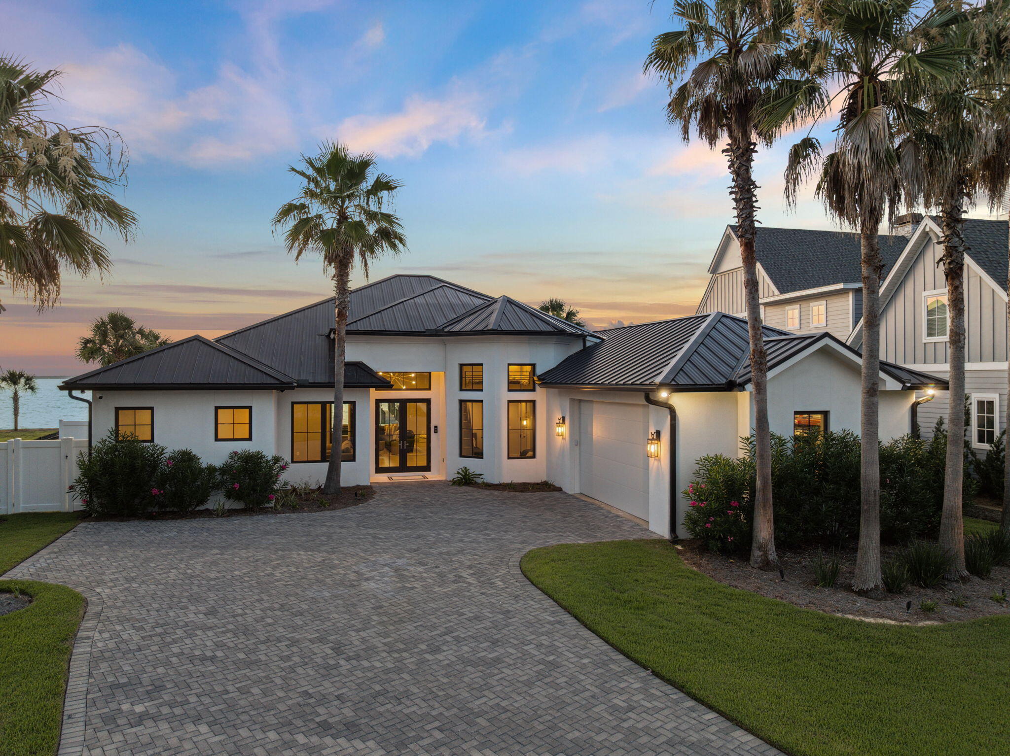 A waterfront location - perfected! Situated on a pinnacle lot on the prestigious Four Mile Point along Greater Driftwood Estates, 31 Driftwood Court stands as an epitome of elegance and modern luxury with panoramic views of the Choctawhatchee Bay. This magnificent one-level waterfront estate, freshly reimagined through an extensive renovation completed between 2021 and 2022, offers an expansive living space encompassing 3028 square feet heated and cooled, on 0.73-acre meticulously landscaped lot, with 113 feet of prime bay frontage.Upon entering, you are welcomed into a world of refined, yet modern sophistication. The home boasts five spacious bedrooms and four full bathrooms. The entire residence was meticulously restructured, retaining only its original concrete block ex terior walls, concrete slab, and roof trusses. Every other element, from new framing to a state-of-the-art geothermal HVAC system, was crafted anew to ensure comfort, style, and efficiency.
Luxury abounds with Wolf and Sub-Zero appliances gracing the kitchen, complemented by new cabinetry, countertops, and fixtures that reflect the highest standards of design. Modern lighting throughout. The living spaces are adorned with curated Restoration Hardware furnishings, providing an ambiance of comfort and style.
The primary waterfront suite, an enclave of tranquility, offers a private retreat with expansive views, complemented by an elegant en-suite bathroom. Each additional bedroom and bath is thoughtfully designed, ensuring privacy and comfort for family and guests alike. An additional waterfront bedroom/bath is the perfect space for a guest suite or private office, together with 3 further bedrooms, one with an extra elevated sleeping loft.
Step outside to discover a private oasis. The newly installed heated pool, surrounded by pristine pool pavers, promises countless days of leisure and enjoyment. The outdoor space is beautifully reimagined with entirely new landscaping with professional lighting connected to the home's automation system.
Noteworthy features include direct deep water access with a new 20,000 lb boat lift and dual jet ski lifts, perfect for aquatic adventures. The seawall and rip rap were replaced and elevated by 18 inches.
New pristine white stucco on exterior, all-new high impact-rated storm windows and doors, and a 2022 metal standing seam roof provide peace of mind. The integral garage, with its increased 9 ft height and insulated doors, provides ample space and convenience. The property has a new state-of-the-the-art geothermal HVAC system, upgraded 400 amp electrical system, new water heater, and full house automation system ensuring it's a smart home monitored and controlled from any location; perfect as a primary or second residence.
31 Driftwood Court is more than a waterfront home; it's a statement of luxurious living, offering the perfect balance of elegance, modern convenience, and breathtaking natural beauty. Experience life at its finest in this extraordinary Santa Rosa Beach waterfront sanctuary.