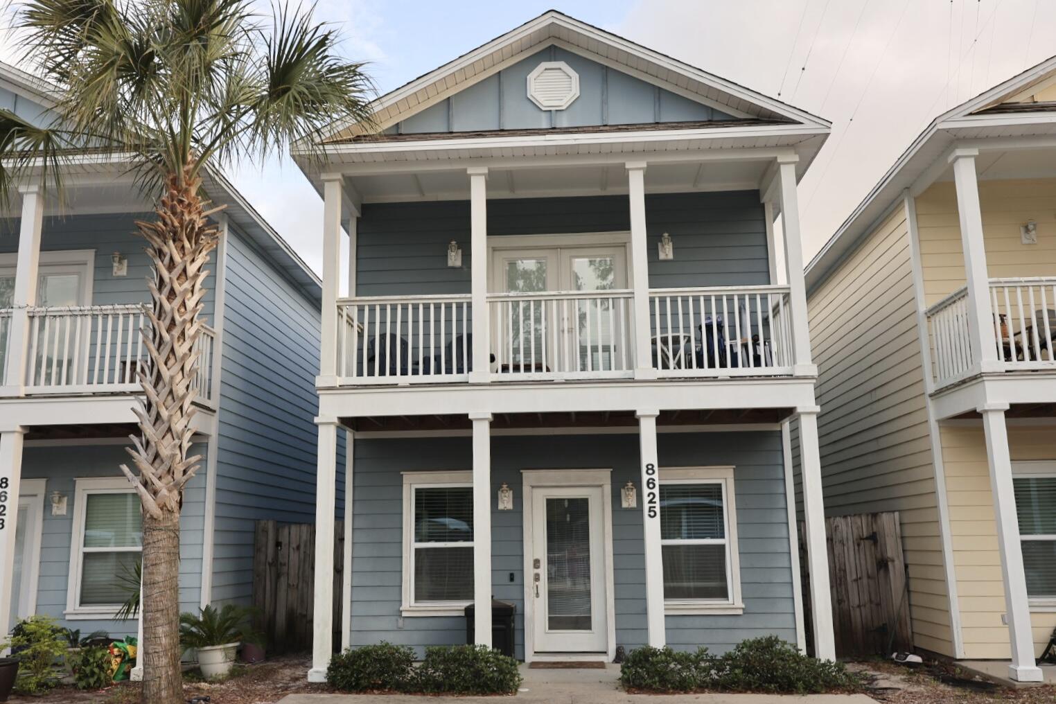 Located just minutes from the beach, shopping, and dining, this beautifully maintained home is in a gated community right across the street from the pool & is a perfect as a private residence or short-term rental. Featuring tall 10-foot ceilings and brand new LVP flooring on the lower level, the home offers a bright, open layout with a furnished living and kitchen area (bedroom furnishings not included). All stainless-steel appliances and washer/dryer. Shaker style wood cabinets and Carara White Marble counters with an island. HOA fees cover pool maintenance, garbage, lawn care and the security gate. The primary bedroom is conveniently located on the lower floor with a private door to the backyard, while upstairs boasts spacious secondary bedrooms perfect for guests or family.