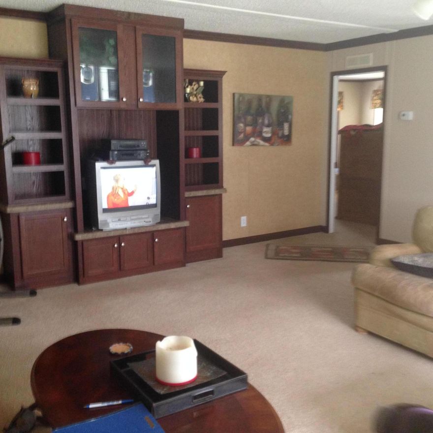 This is an excellent shape manufactured home on 12.30 acres. The property is fenced and cross fenced. There is a barn with 2 stalls. There is a chicken coop. There is pasture for all your horses. As well as a 12x20 RV parking pad. This manufactured home has a very large living room with open kitchen and breakfast bar. Large master suite with a huge master bath. His and hers closets. There are two additional bedrooms and an additional bath in the hall area. There is an 8x30 covered porch and the end of this home.