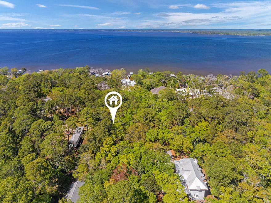 Double Corner Lot! With a perfect position in Magnolia Beach community on the Choctawhatchee Bay, this Daisy Drive double lot offers highly coveted Bay views of endless blue-green water to the east and west along with the perfect elevation for building a dream Bayfront magnum opus residence. Magnolia Beach is a much sought-after neighborhood in the heart of Point Washington State Forest with no HOA and easy access to the Bay lifestyle with boating, fishing and paddleboarding from the community boat launch area located within walking distance.  In addition, this spacious 50x150 foot lot is less than 5 minutes from Grayton Beach and 30A with its eclectic menagerie of dining and entertainment options. Special Note: Mobile homes are not permitted due to Deed restrictions.