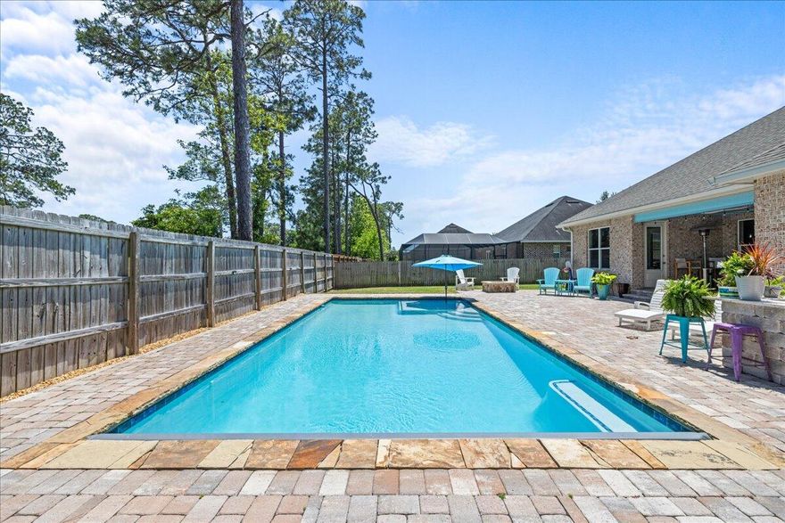 NO HOA! MOTIVATED SELLER! - Welcome to this beautiful home with a stunning pool located in Magnolia Woods. Built by Huff Homes, this home boasts plenty of custom features throughout. This 2,228 square foot home features 4 bedrooms and 3 full baths, with an open concept layout. Upon entry through the covered porch, you're greeted by the foyer, leading into the oversized living room that seamlessly connects to the kitchen and dining area, creating a welcoming atmosphere. The kitchen is equipped with top-of-the-line stainless steel appliances, including a gas range, brand new dishwasher, microwave, and refrigerator. The kitchen also boasts 42' upper cabinets and a large pantry offering you plenty of storage space for all your kitchen needs. Just off the living room are three bedrooms and two full baths. Among these bedrooms, two share a hallway bath with a walk-in tiled shower, while one features its own ensuite bath with a shower/tub combination. The primary suite, also accessible from the living room, has a luxurious bath complete with a walk-in tiled shower, dual vanity with granite countertops, and a spacious walk-in closet.

Step outside through the French doors to discover a space for outdoor entertainment and relaxation. The fully fenced backyard includes a 10x16 shed and an extensive paver patio area surrounding the heated saltwater pool with motorized cover. A built-in gas fire pit with crystal rocks adds a touch of elegance, while an outdoor kitchen area with counter height bar provides a perfect spot for outdoor grilling and entertaining guests.

Experience the magic of this remarkable Florida home - schedule your showing today!