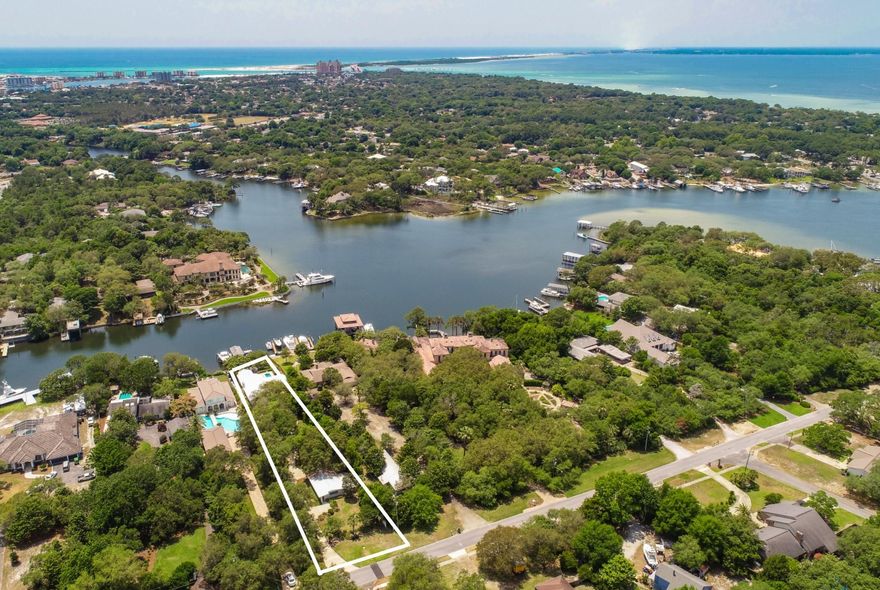 LOCATION, LOCATION, LOCATION! WATERFRONT HOME WITH DEEP WATER ON JOE'S BAYOU! WILL NOT BE ON THE MARKET LONG! If relaxation is what you're looking for, enter this gated estate with 75ft. of waterfront luxury on the prestigious Joe's Bayou. Few properties have the charm and solitude that surrounds this home. Step inside and you'll be amazed at the openness of the living, dining, and media room. This home is great for entertaining with its recently remodeled kitchen which boasts a Dacor 6-burner stove and stainless appliance package that complement the granite counters and backsplash. All new flooring was recently installed throughout the main house and guest quarters. The master suite with luxury bath and Jacuzzi tub overlook the sparkling, heated pool and the Bayou.