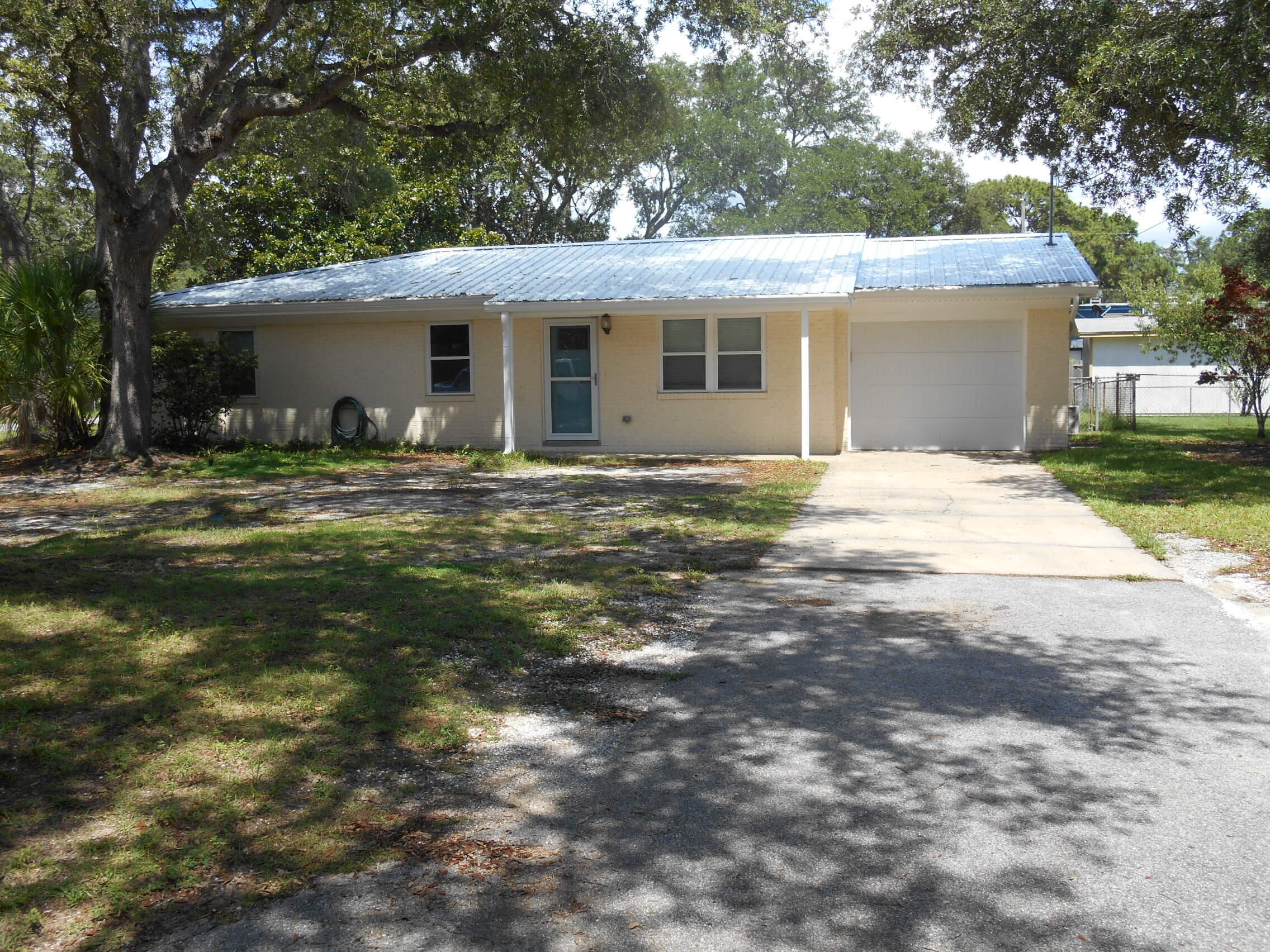 Renovated well maintained cement block home on a corner lot conveniently located in Shalimar, close to Eglin, Hurlburt, and the Beach. Home was completely rewired in 2018, new metal roof in 2021, screened patio, Mini split A/C for the garage, A/C air handler new May 2025, new windows throughout with transferrable warranty in 2022, tile shower in Master Bath, new doors, interior trim, exterior trim and gutters. newer water heater, Kitchen features Stainless Steel appliances and granite/quartz (?) countertops.Multiple offers received, Highest and best by noon on 6/26.