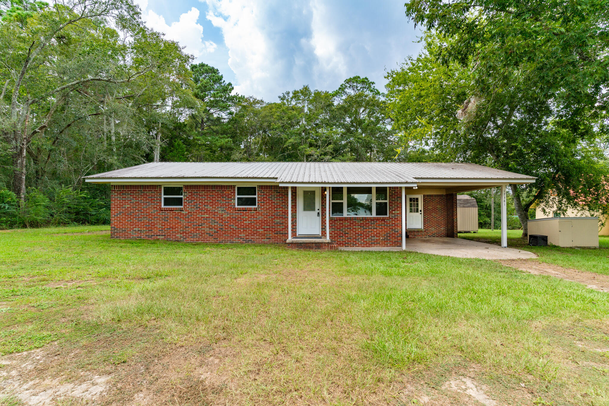 A very charming, brick home in the country that is only 15 minutes to Florala and the 500 acre Lake Jackson which is a very popular lake for skiing, boating and swimming. This lovely home has been completely remodeled a couple of years ago!!! Interior has been painted a neutral color in 2024. While a metal roof, lovely interior and exterior doors were hung. Pex plumbing with manifold , new water heater, new HVAC system, LVP flooring, granite counter tops, all new stainless steel appliances along with lighting. A laundry room is under the carport. Everything was done!!! Nearly 1/3 of an acre with a 12x12 stick built storage unit for all your gardening tools and more!!! This house will be the perfect home for those that love peace and quiet country living.