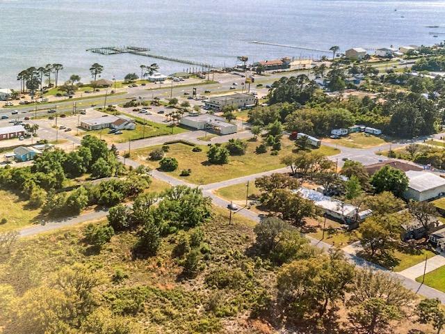 Prime Commercial Site! Unobstructed water views to the Sound! Fantastic location within sight of the Navarre Beach bridge. Adjacent to the proposed future ''Navarre Town Center''. A tourist and resident live, work, play, shop, and dining destination.''This parcel ID # 21-2S-26-2710-00800-0110 (.69 acres), and the adjacent vacant land parcel to the west, parcel ID # 21-2S-26-2710-00800-0120 (.55 acres), are being offered for sale together. This offering represents a total of 1.24 acres with 270' of Hwy. 98 frontage and 200' deep.The seller is the visionary for the proposed ''Navarre Town Center''. Please see the proposed 'Navarre Town Center' renderings in 'documents tab'. The development of a high end hotel, condo, and/or restaurants here would be ideal. Buyer to verify all.
