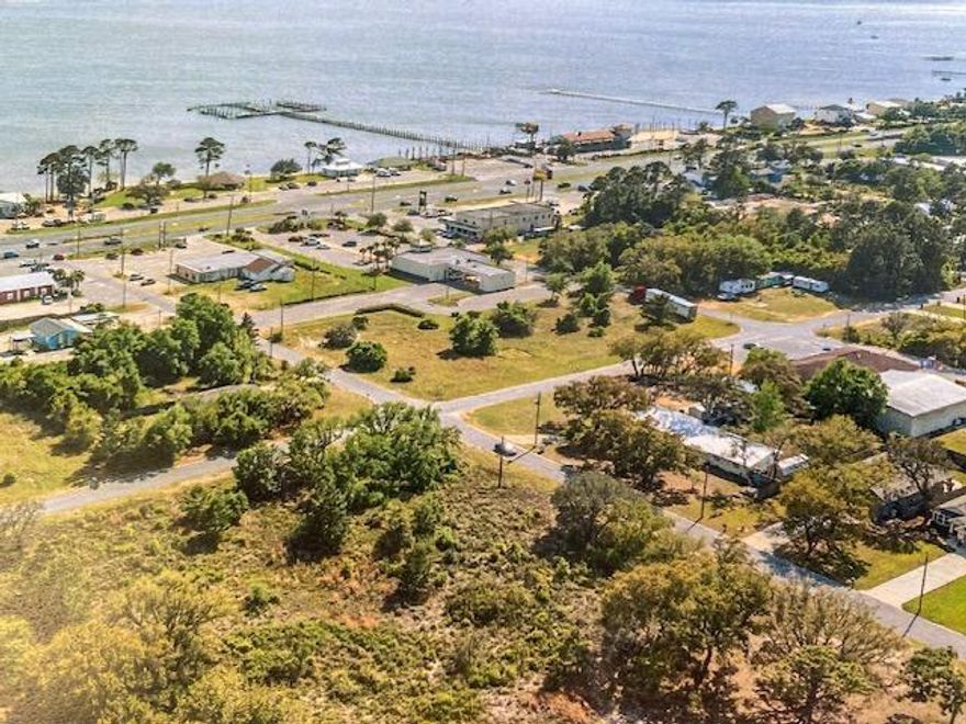 Prime Commercial Site! Unobstructed water views to the Sound! Fantastic location within sight of the Navarre Beach bridge. Adjacent to the proposed future ''Navarre Town Center''. A tourist and resident live, work, play, shop, and dining destination.''This parcel ID # 21-2S-26-2710-00800-0110 (.69 acres), and the adjacent vacant land parcel to the west, parcel ID # 21-2S-26-2710-00800-0120 (.55 acres), are being offered for sale together. This offering represents a total of 1.24 acres with 270' of Hwy. 98 frontage and 200' deep.The seller is the visionary for the proposed ''Navarre Town Center''. Please see the proposed 'Navarre Town Center' renderings in 'documents tab'. The development of a high end hotel, condo, and/or restaurants here would be ideal. Buyer to verify all.