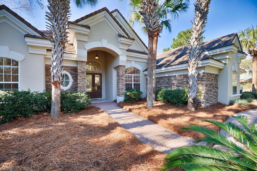 An original model home built by the luxury builder, Arthur Rutenberg, now proudly awaits a new buyer in the upscale residential community of Regatta Bay Golf and Yacht Club. Curb appeal abounds with lush landscaping and an inviting facade, plus this home boasts a rare three-car-side-loading garage - all situated perfectly to enjoy lake and hole #2 golf course views. This spacious home will be a favorite for families, as 4 bedroom homes are in demand. This split bedroom plan allows for privacy, while the large Kitchen and Leisure Room offer a natural gathering space. The bonus room is exactly that - now being used as a home office, one may opt to use as an exercise room, or a children's recreational room.