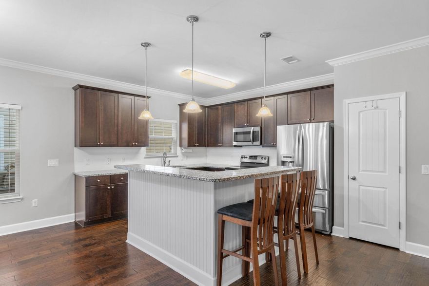 Welcome to this perfectly located 4 bedroom, 2.5 bath Niceville home! Built in 2016 this has all the updates and finishes you've been looking for. Enter in the front door and you'll love the hard surface floors extended throughout the entire home along with crown molding and brushed nickel finishes. Downstairs you'll find a great open floor plan with a half bath and a spacious living room that leads to the well-appointed kitchen featuring granite countertops, stainless appliances with a french door refrigerator, drop down pendant lighting, and a functional kitchen island with plenty of room for bar stools. The eat in kitchen space is large for your dining room furniture and from there is a back door to the fantastic screened in back patio. You will love the low maintenance backyard