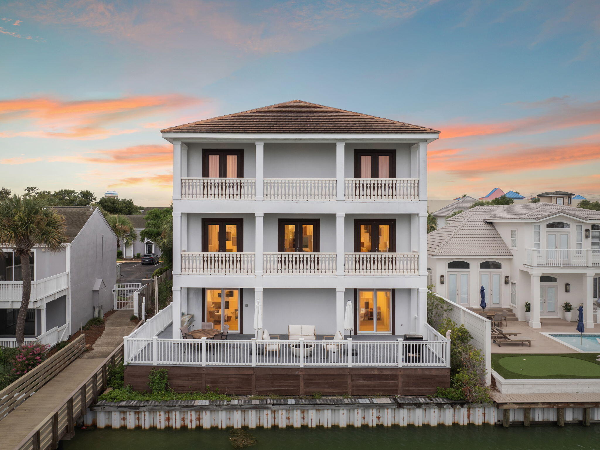 A stunning lakefront estate in the heart of Destin, Florida, this eight-bedroom, six-bathroom retreat offers a rare combination of privacy, elegance, and walkable beach access. Located within a secure gated community and just minutes from the Gulf, this residence embodies coastal luxury at every turn.Spanning three thoughtfully designed levels, the home offers exceptional comfort and functionality. Recently updated with fresh paint, furnishings, and decor. On the first floor, a two-car garage provides ample storage, while a spacious recreation and workout room with a full bathroom including a stand-up shower creates the perfect space for active living. A large bunk room comfortably sleeps 6 to 8 guests, making it ideal for hosting extended family or vacation renters. The second floor serves as the main gathering level, where two generous bedrooms each with large walk-in closets complement the expansive living area. The open-concept kitchen is fully appointed with quartz countertops, upgraded appliances, and picturesque views of the lake. An oversized kitchen island with seating for eight offers a central hub for entertaining and casual dining. The spacious living room features ample seating, a built-in entertainment center, and access to one of the home's multiple outdoor decks. Two full bathrooms and a fully equipped laundry room complete this level.
Upstairs, the third floor boasts four large fully furnished bedrooms and access to a private balcony and covered porch. The bathrooms are designed with quartz countertops, glass-enclosed showers, and double vanities for a spa-like feel. A Jack and Jill bathroom connects two of the guest bedrooms, both of which are appointed with queen beds and flat-screen TVs.
Fully furnished and turnkey, the home is rental ready with a projected income of over $213,000 annually, offering an exceptional opportunity for investors or those seeking a second home along Florida's Emerald Coast.
With deeded access to the private beach just a short walk away and resort-style amenities including a community pool, this property offers an unmatched blend of serenity, style, and convenience. Moments from Destin's premier shopping, dining, and recreation, it delivers the ultimate expression of luxury coastal living