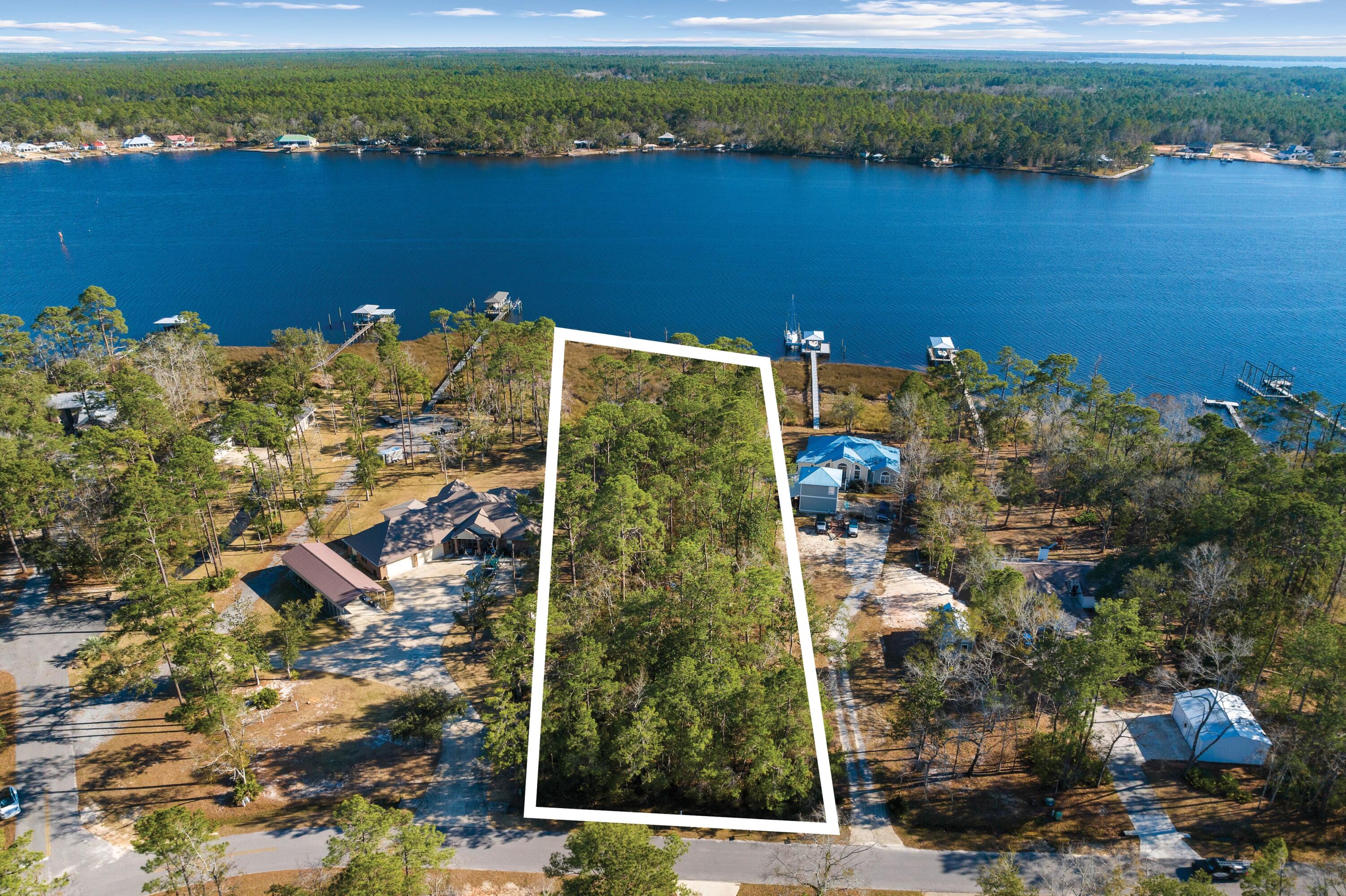 Discover the tranquility of waterfront living in Lagrange Shores, where a rare opportunity awaits on more than one acre of bayou-front property. This 1.3+-acre lot, with .72 acres of uplands, offers a peaceful retreat in a rural setting known for its scenic bay waters and towering oak trees. With no HOA, this property presents a blank canvas for those dreaming of a waterfront lifestyle. Located close to the new Freeport Middle School, set to open in August 2024, and the Freeport Regional Sports Complex, the property combines the allure of secluded living with the convenience of nearby amenities. A short drive takes you to Freeport's Publix, shopping, dining areas, and the renowned white sand beaches and unique charm of South Walton County and 30A. Boating enthusiasts will appreciate the scenic boat ride options to Destin Pass or Panama City via Choctawhatchee Bay and ICW. Away from the crowds and traffic, this property offers a peaceful escape while still being connected to the vibrant community. As Freeport continues to grow, waterfront homes in this neighborhood have consistently sold over $1 million. This property, which includes a survey and completed wetlands study, represents an exceptional opportunity to build your dream home in a fast-appreciating area. Embrace the chance to make your waterfront dreams a reality in Lagrange Shores.
