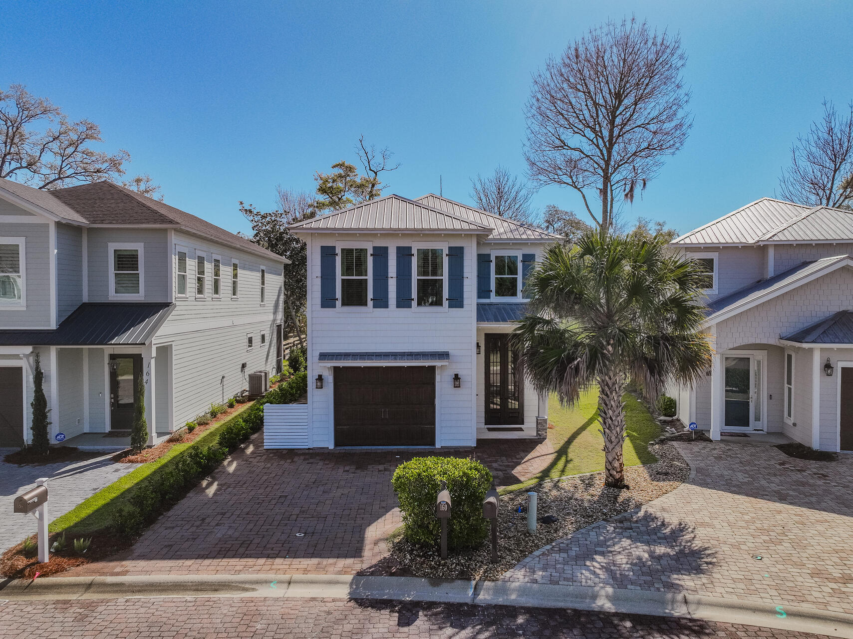 Offering a stunning waterfront retreat with high-end finishes. Enjoy waterlife in this beautifully designed custom-built home, a true boater's dream. This 4-bedroom, 3-bathroom residence showcases luxurious upgrades and elegant craftsmanship throughout that includes crown molding, custom shiplap walls and ceilings in select areas. Soaring high ceilings, luxury vinyl flooring and large windows that welcome an abundance of natural light create a wonderful combination of warmth and openness. The fabulous gourmet kitchen, the heart of the home, is equipped with honed granite countertops, a WOLF gas range and oven, a SubZero refrigerator, and a SubZero ice maker--all centered around a majestic island that ties the space together. The master bedroom includes a private sitting room with a built-in bar and mini-fridge, an extra large double walk-in closet with custom shelving and a spa inspired ensuite bath with a luxurious soaking tub and massage jet spa shower. This waterfront gem, designed for both relaxation and entertaining, offers a perfect blend of luxury, comfort, and timeless style. All closets provide custom shelving and the garage has an epoxy-coated flooring. New HVAC system and fence around the backyard. This elegant home is located in the charming neighborhood of Sacred Oaks, with moss covered oak trees and cobblestone paved streets, and convenient to grocery shopping, A+ rated schools, Sacred Heart hospital and less than 10 minutes to the sugar white sand beaches of 30A.