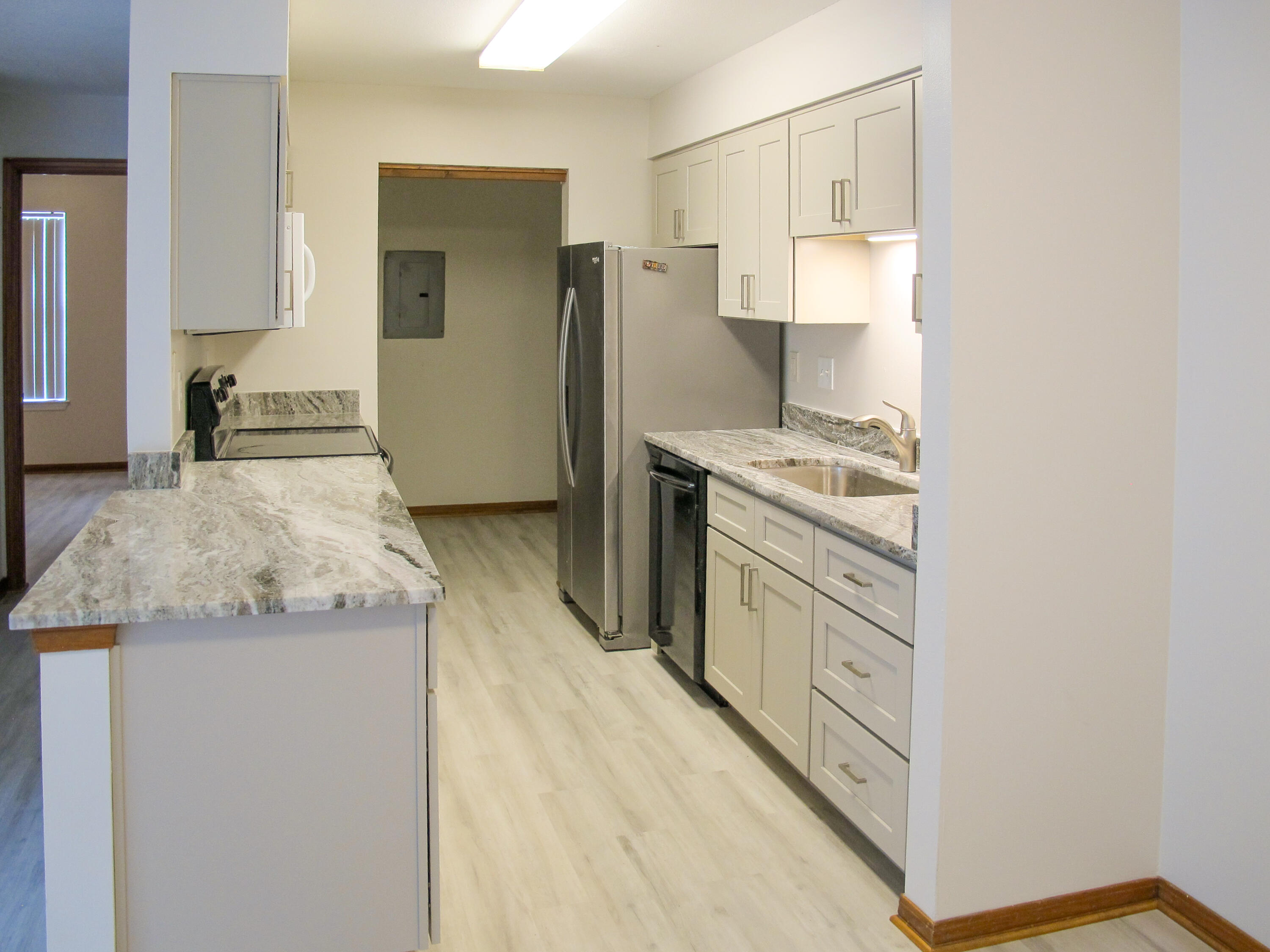 Freshly upgraded one-story townhouse with open living/dining/kitchen and split floorplan, each bedroom with its own bath. End unit offers added privacy. Kitchen and front bath newly renovated with beautiful granite counters and all new cabinetry, providing beauty and functionality. New LVP flooring and paint throughout. The kitchen features ample counter space and storage, newer refrigerator and microwave, smooth-top range and dishwasher. The utility room behind it includes pantry shelving as well as inside washer/dryer hookups. Skylights enhance both baths with natural light. Back bedroom has a back door opening out to the open patio and large fenced backyard. Lockable storage closet with outside entry from the back patio. See additional details No smoking. Pest control is included in the rent. Pets must be approved by the owner with an additional $250 security deposit per pet and a non-refundable $150 administrative pet fee (small pets only, please note that privacy fencing belongs to unit #2 and may not completely close in the yard). Online application, background check fee $55. Easy rent payment system offering Credit Building to help boost your credit score (fee).