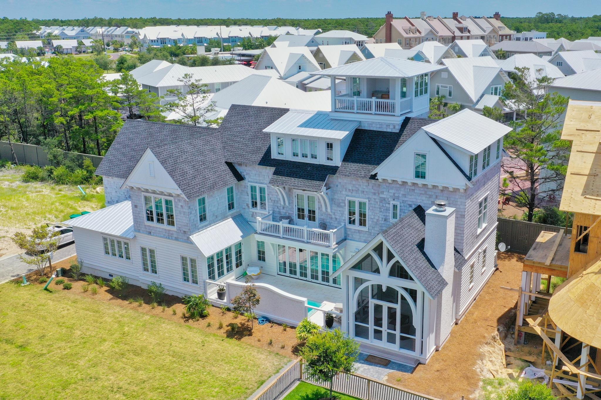 Amazing views of the Gulf from this architecturally designed beach home in Grace Point on 30-A. This home was designed for family living offering multiple bedroom suites and family areas to gather. The gorgeous hardwood floors are made from reclaimed barn wood and the 300 year old beams throughout the home are spectacular. The chefs kitchen features custom cabinetry, an oversized island, Sub Zero and Wolf appliances, quartz countertops, and a custom wine cellar. There's an outdoor kitchen and fireplace surrounding the pool.The first floor master suite features Carrera marble, a walk in shower, and custom cabinets and opens to a private courtyard.