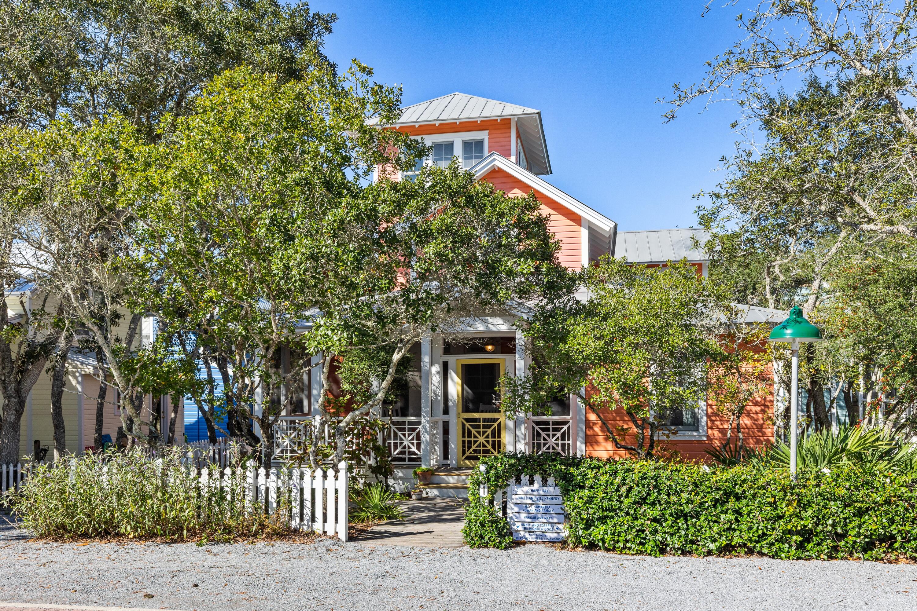 Oh Happy Day is a traditional Florida beach cottage that will bring back favorite memories of your family's summer vacations. Located six lots in from 30A, just a few minutes stroll to the beach, shops, and restaurants in town center. Relax on the front screened porch shaded by lush landscape. The living area is filled with light and sense of grand spaciousness provided by cathedral ceiling. Natural finished pine floors are found throughout the cottage. The galley kitchen with breakfast bar is open to the dining area. A side entrance leads to a mudroom, laundry room with storage and direct access to the kitchen. Two guest bedrooms, each with full baths are also on the first level. French doors off the dining room open to a private screened porch. Picnic in the backyard under the shady grove of oak trees. Overlooking the living room is a sitting nook with an abundance of shelves to fill with your favorite books and collection of seashells. The primary bedroom and bath are secluded at the rear of the second level with private balcony. On the 3rd level above the master suite is an enclosed tower with sofa. Views of Seaside's roof tops from the balcony off the tower are an amazing site to see! The house is built for comfort and year round enjoyment. Room to add guest cottage.