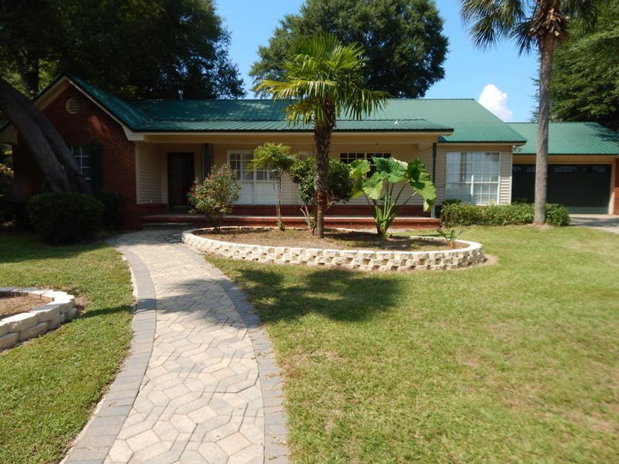 Don't miss out on this exclusive home in a very exclusive neighborhood. Savannah Lane is a peaceful, dead-end street that is tree lined and a great place to live. Solid wood floors and tiled floors throughout, except for the 3 bedrooms are carpeted for warmth and comfort. This is an all brick home with a front sitting porch, a great view overlooking paradise. There is a split bedroom floor plan, a custom kitchen with lighted Maple cabinetry, tiled floors/ back splash. Gas fireplace in L/R. The master has his/hers walk-in closets, whirlpool tub & tiled shower. There is aheated & cooled enclosed sun room out back. The amazing workshop is insulated and sheet rocked with can lights & water. A Custom built home with lower county property taxes and no HOA restrictions! Hurry on this one!