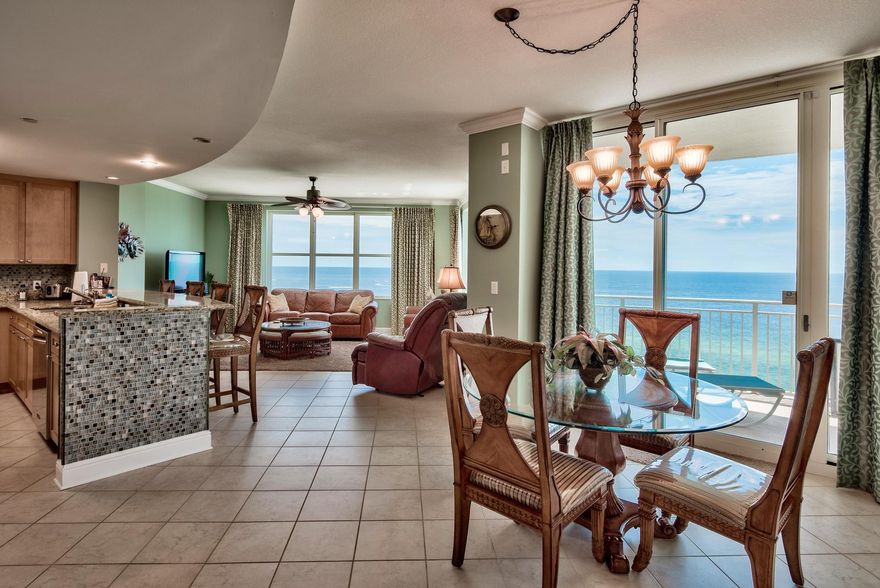 Stunning East corner unit with raised ceilings (9 ft.), crown molding, tile floors in the main living areas and stainless appliances. This is the LARGEST floor plan at Aqua boasting not one but 3 balconies. Every room has balcony access and an en-suite bathroom, a rare treat! Unit 1101 is currently a rental unit in prime condition with good income. It is being sold fully furnished with & beautifully decorated. Capture stunning Gulf views from nearly every room with oversized glass windows and doors. Access the Gulf front balcony from the living/dining area and master bedroom and there are two additional private balconies for the guest bedrooms with Bay views. The interior offers an open floor plan and fantastic kitchen with granite breakfast bar & countertops and custom mosaic backsplash.