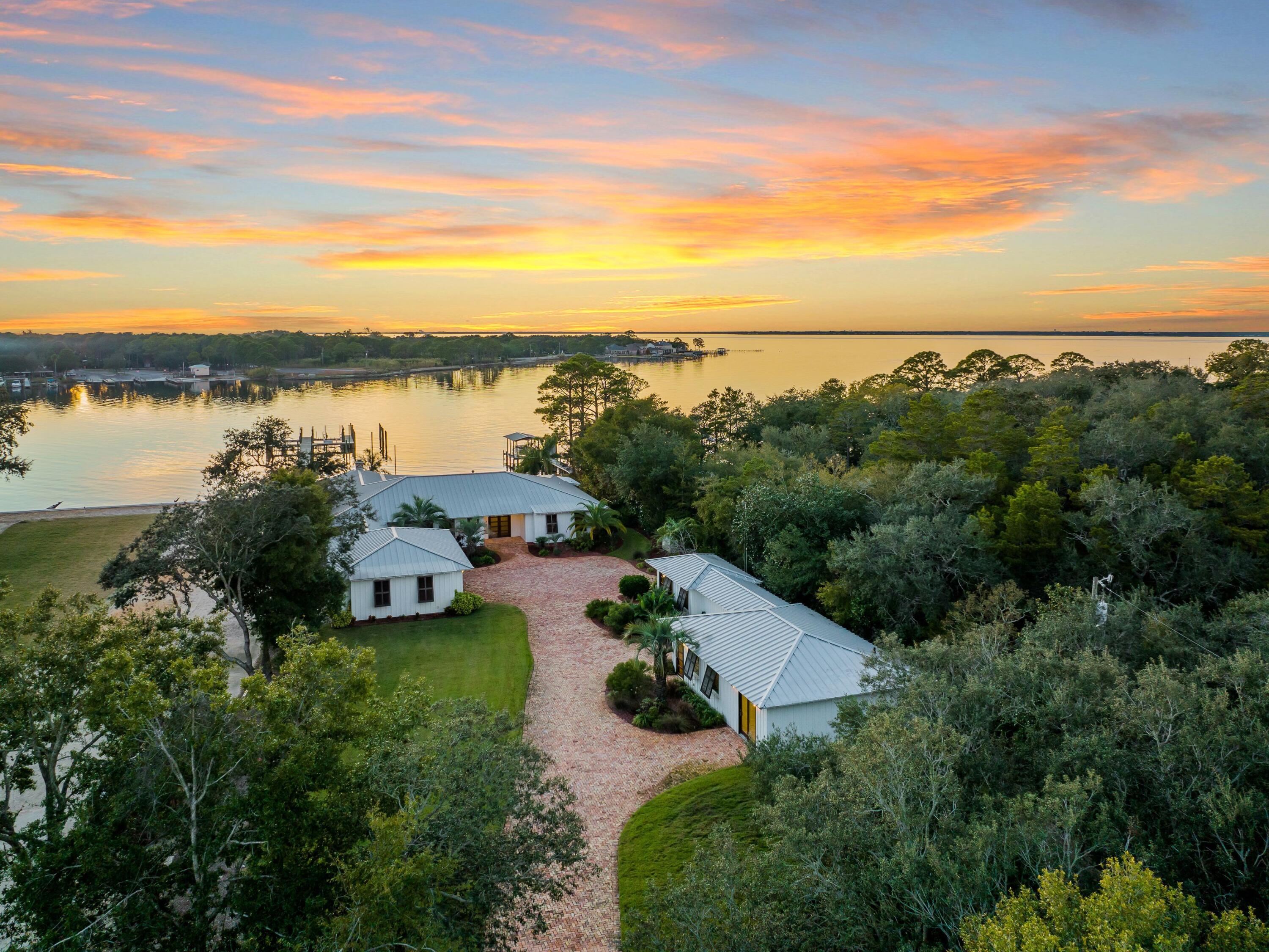 Experience unparalleled waterfront living in this stately home that boasts its own private beach, deepwater dock and guest house with two bedrooms and bathrooms. A perfect marriage of indoor and outdoor living that's both private and conveniently located near the best of everything in Destin, this retreat capitalizes on remarkable views across Joe's Bayou to the Choctawhatchee Bay. An impressive brick driveway leads to an oversized garage and the home, situated amid lush landscaping, which has been thoughtfully remodeled. No expense was spared in this five-bedroom, six-and-a-half bath retreat, including pecky cypress ceilings, stunning wood flooring and open living spaces for the best of Florida coastal living.