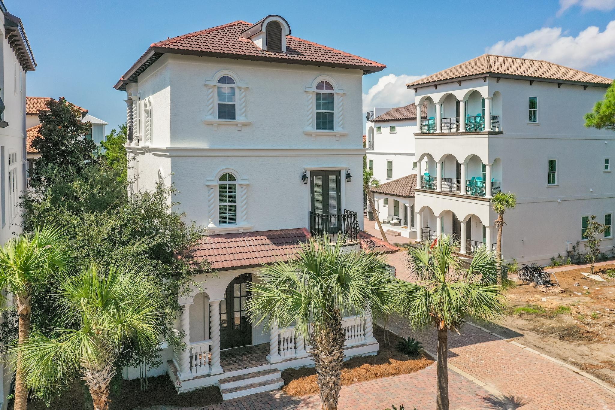 Incredible 4-bedroom, 4.5 bath Mediterranean style home located on a corner lot nestled away in the exclusive, gated community of Palmeira Villas at Seagrove beach. This home is only 150 yards from the Seagrove Place public beach access, less than a 3 minute walk! Beautiful architecture abounds throughout this home accentuated with spiral columns and stunning arched entryways and windows. The third level encompasses a great outdoor entertainment space equipped with a kitchenette, grill, and a fireplace. There is also a private splash pool with a waterfall feature for ultimate relaxation. Upon entering the home you are greeted with raised ceilings, gorgeous crown molding, recessed lighting, and travertine flooring throughout the entire ground level, ideal for beach living.