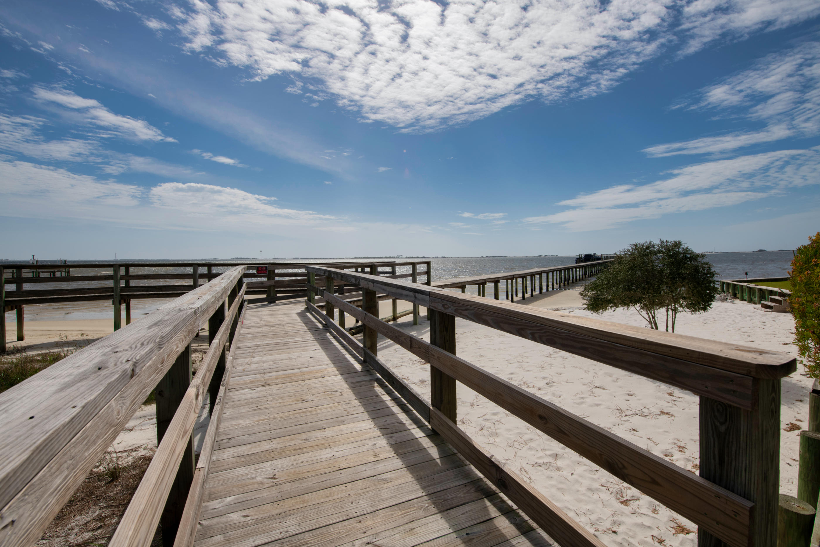 Unbelievable Intercoastal water views.Bright and open kitchen withquartz counter tops. Master bedroom with spalike bath and his and her closets, French doorsgoing out to deck. Bedrooms on the other side ofhouse can be in-law quarters. Office w 6ftglass doors, Luxury Vinyl Plank Flooring,going out to screened in large deck withincredible water views. Oversized garage withgranite grip floor covering, kitchen / craft room,powder room, and gym. Lower deck area isscreened in, also large deck with steel cable and more water views. Built in shed for added storage. Beautiful River rock lines the landscape and palm trees. Community dock with deeded boat slip recently renovated with water and electric!