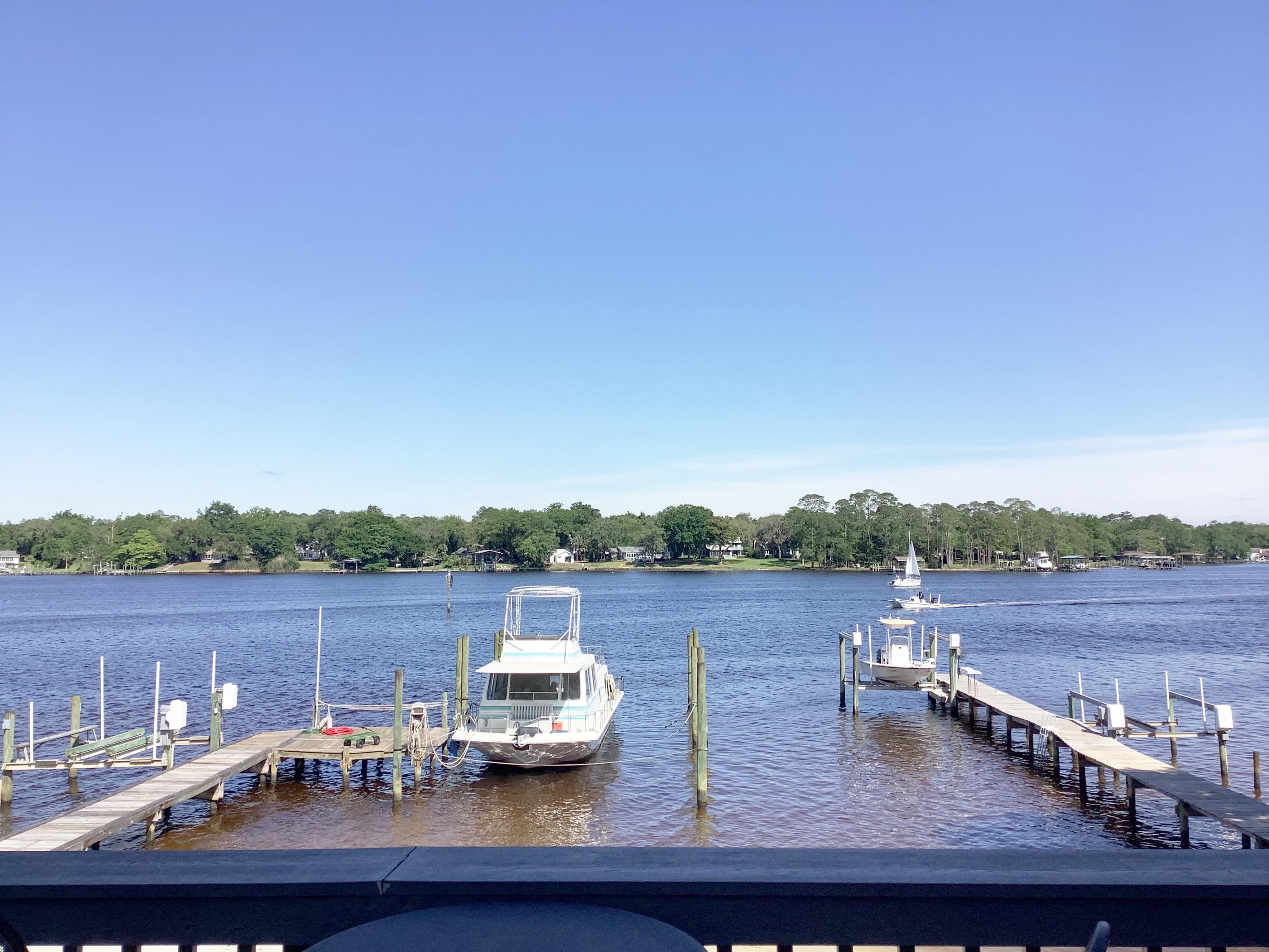 63' on the Bayou! Boater's Delight! Never before on the market! 1 owner, END unit, Bayou front Town home has shared dock and private beach, BEAUTIFULLY remodeled kitchen with dual fuel stove, sleek European style solid, cherry hardwood cabinets, w, soft close drawers, granite counters, stainless steel appliances, & built in office. Gorgeous red oak hardwood floors and the most breathtaking views imaginable! 2 masters. 1 on 1st floor and another on 3rd floor. Private entrance for downstairs, ensuite Master complete w/murphy bed. Walk right out to the Hot Tub, enormous deck, beach & dock with electric & water. 3rd floor Master has vaulted ceiling, Dbl vanities in bath & custom, European cabinetry. 200' balcony overlooks stunning views. Complete with gas grill. Gas stub on deck for fire pit