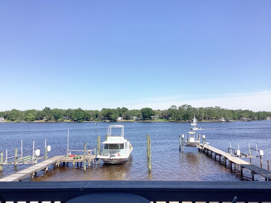 63' on the Bayou!  Boater's Delight! Never before on the market! 1 owner, END unit, Bayou front Town home has shared dock and private beach, BEAUTIFULLY remodeled kitchen with dual fuel stove, sleek European style solid, cherry hardwood cabinets, w, soft close drawers, granite counters, stainless steel appliances, & built in office. Gorgeous red oak hardwood floors and the most breathtaking views imaginable! 2 masters. 1 on 1st floor and another on 3rd floor. Private entrance for downstairs, ensuite Master complete w/murphy bed. Walk right out to the Hot Tub, enormous deck, beach & dock with electric & water. 3rd floor Master has  vaulted ceiling, Dbl vanities in bath & custom, European cabinetry. 200' balcony overlooks stunning views. Complete with gas grill. Gas stub on deck for fire pit