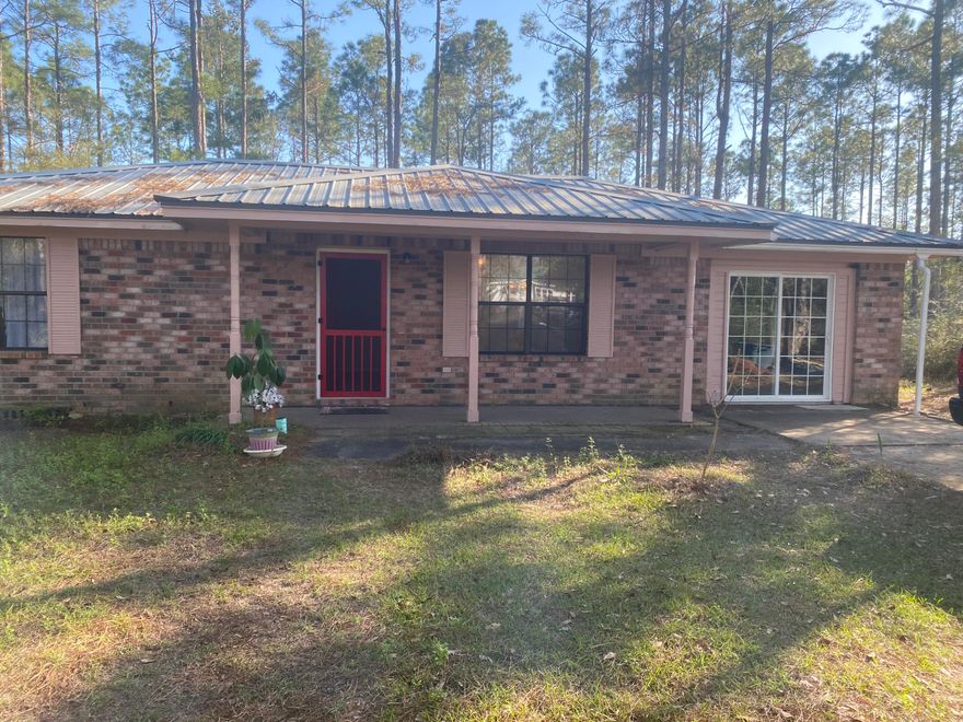 Just 3.5 miles South of I-10 in DeFuniak off 331 S, off  Hawthorn Road. Nestled in tall trees is this 1994 built  all brick home with a metal roof that has just been renovated with freshly painted walls and new vinyl and carpet throughout.   Home has 3 bedrooms, and an enclosed garage that could be 4th bedroom if closet is added or use as a bonus room/den.  Laundry room is large and could be converted to a master bathroom.  Washer and dryer included as well as stove and refrigerator.  Land is level and lightly wooded.  New central air/heat Oct. 2022, appx. 10 minutes to Freeport and 30 minutes to South Walton.