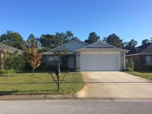This is a great home in a great Navarre Subdivision! Three bedroom, 2 bath home with cathedral ceilings, plant shelving and neutral paint colors throughout. The kitchen features a breakfast bar, pantry and tiled backsplash. Very little carpet, only in the bedrooms and laminate wood flooring throughout the home. Master suite has a walk-in closet, garden tub and double vanity. You'll enjoy the open patio, great for entertaining with private backyard. Very close to Holley Navarre Schools, shopping, the beach and much more!