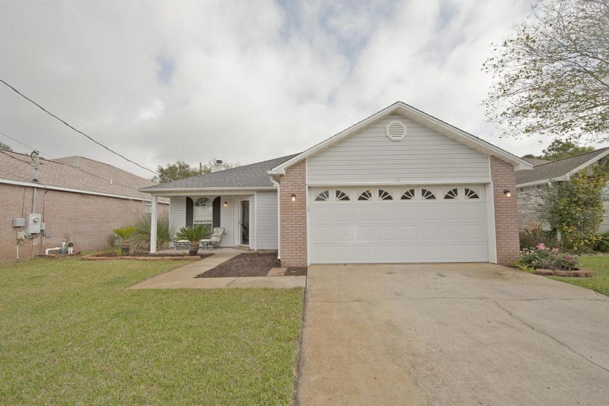 This meticulously maintained home is ideally located just minutes from Eglin AFB, beautiful beaches, and only a mile west of Hurlburt Field. Upon entering, you'll be welcomed by a spacious living and dining area featuring a coffered ceiling with crown molding and a cozy wood-burning fireplace. The eat-in kitchen boasts tile flooring, a pantry, a breakfast bar, and ample space for a second dining table, making it perfect for both everyday meals and entertaining.Two additional bedrooms offer versatile space for use as bedrooms, a playroom, or a home office. The second bathroom is generously sized, making it an ideal shared space for family or guests. The large master suite includes a private entrance to the covered patio, while the master bath is designed for relaxation with a vanity and a separate water closet for added privacy.

Step outside to a spacious backyard, perfect for summer barbecues and outdoor gatherings. The fenced yard provides a secure area for pets to roam freely, with the added benefit of a government-owned property beyond the fence, ensuring privacy and tranquility.

This home offers a wonderful combination of comfort, convenience, and outdoor living in an ideal location. Don't miss outschedule your showing today!