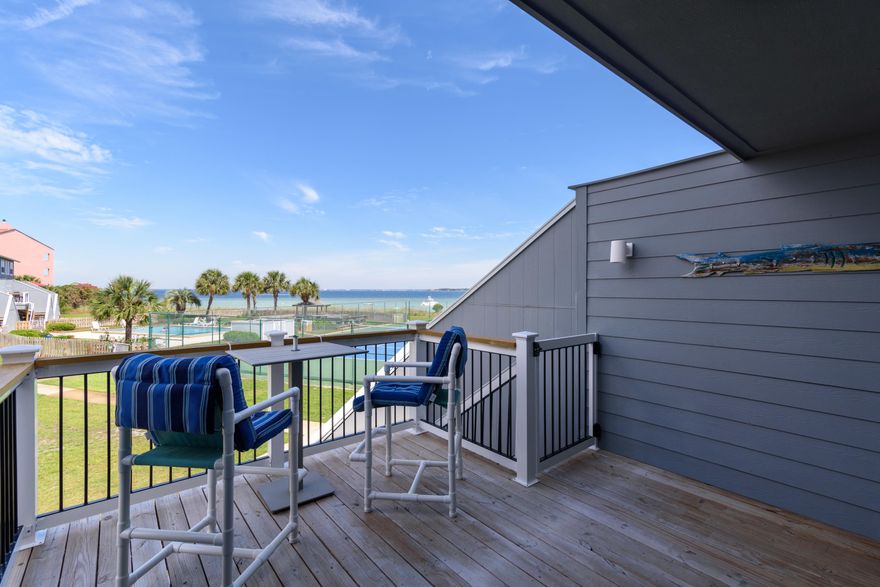 Nestled between the Gulf and the Sound on Pensacola Beach and renovated in 2018, this delightful beach retreat is full of wonderful features! With coastal-luxe kitchen and bathroom updates, and new paint throughout, you'll be thrilled with the well-appointed kitchen that comes equipped with sparkly quartz countertops, breakfast bar, stainless steel appliances, double oven, oversized stainless sink, under-cabinet lighting with a deep coastal-blue glass subway tile backsplash. You'll also enjoy new luxury vinyl plank flooring throughout the main living floor as well as a convenient half bath and full-size washer and dryer. Just off the living room you'll find a wonderful extension of outdoor living/entertaining space on the spacious balcony offering Sound and Gulf views. Upstairs you'll fin