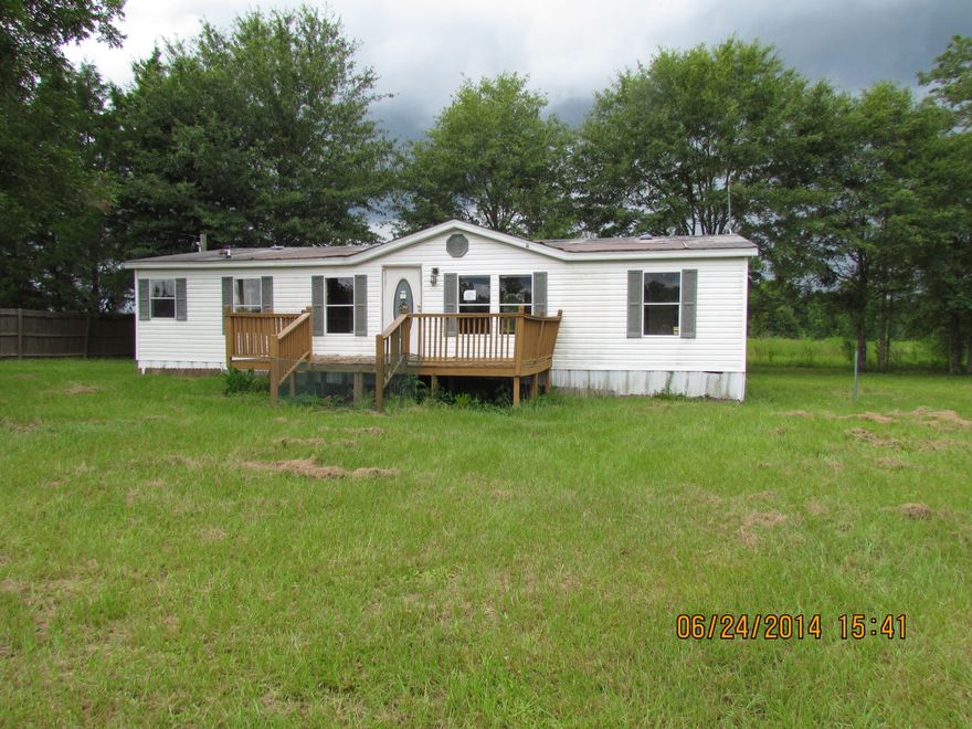 One acre parcel with a 2000 year built mobile home that needs some work. This is a spacious mobile home when you walk in. The kitchen is a good size with lots of cabinet space. There is a laundry room that could have extra space for storage and has access to the side entry door. The master bedroom and bath are very roomy. The mobile home does need work. Property being sold 'as is'. Buyer to verify all pertinent information!