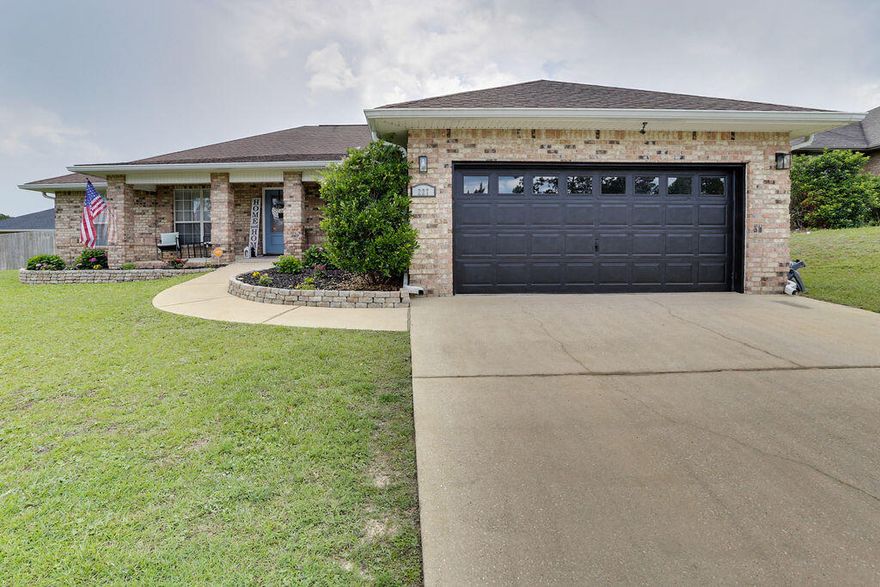 WELCOME HOME! This all-brick contemporary-style home stands boldly on a large corner lot at Alicia Place in south Crestview. This home is nearly 2600 square feet of living space which includes 4 large bedrooms, 2 bathrooms, a dining room and a dedicated flex room to use as an office or anything else that fits your lifestyle.  Vinyl-planked flooring flows through most of the walkable areas with new marble-esque tile recently installed in the laundry room and bathrooms. The expansive kitchen has seemingly miles of countertop space and is open to the massive livingroom complimented by tall cathedral ceilings.  The primary bedroom is located on its own wing of the home including a very generously sized ensuite with a double vanity, two large closets and a separate shower and garden tub.