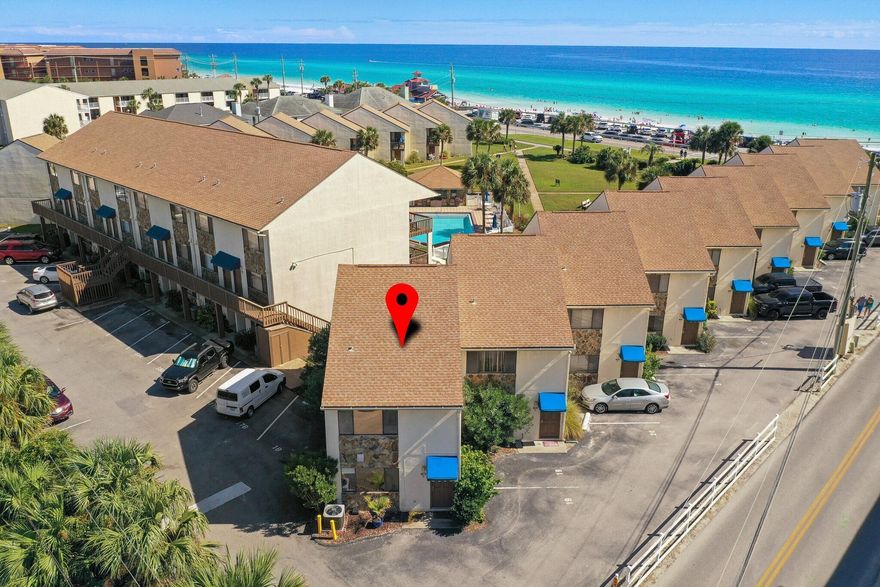 Location, Location, location! This quaint complex is located across the street from the Gulf Mexico, you will love the proximity to the beach access.   In addition, Blue Surf Townhomes offers seasonally heated pool, open lawns, dedicated parking spot for each unit and located centrally for restaurants and activities.   The home is 2 floors with the kitchen, a bedroom and bath on the lower level.  Upstairs is the living space with balcony and bedroom with bath.   Home is ready to make it your own.  Showings on turn days only.