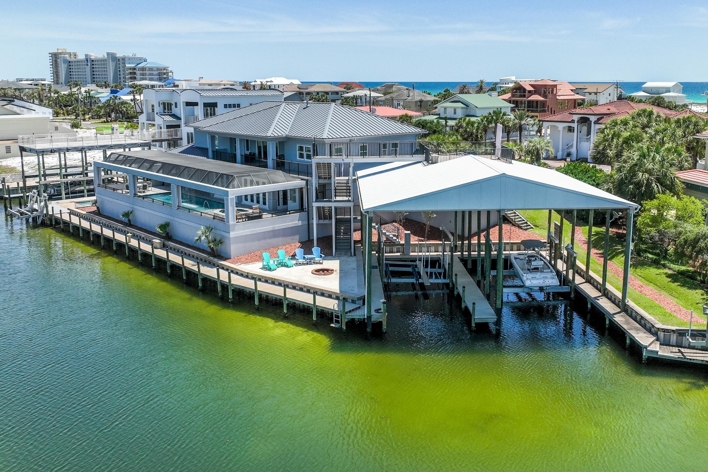 Premier Waterfront gem on Holiday Isle! This harbor canal front home truly is a boater's delight. It boasts over 217 ft on the water, with 3 different deep water slips and dockage. It will accommodate very large boats and even jet skis. This newer custom home estate was meticulously built and designed with all the best upgrades and attention to detail. The estate is located on a quiet cul-de-sac, perfect for a person who wants privacy, peace and quiet. With gorgeous exterior and interior detail, finishes compliment the richness of the residence that offers amazing amenities, magnificent waterfront views and breath taking sunsets.