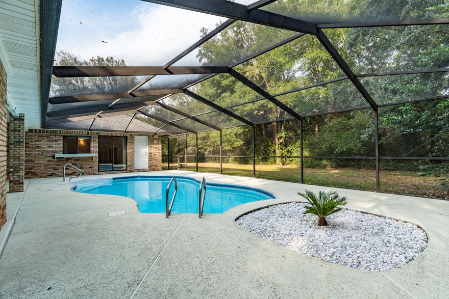 Nestled between the 18th tee and the 10th hole in highly sought after Hidden Creek Estates, this impeccably maintained all brick POOL home is perfect for entertaining, with it's open, flowing floor plan and abundance of natural light. Featuring a formal dining room, Office, large Family room and huge Master suite, even the most discerning of buyers will appreciate the blend of comfort and quality this home offers.The living areas flow seamlessly into the outdoor space where you'll find a large screen enclosed patio and sparkling pool - perfect for cooling off on hot summer days. The peaceful, private backyard is a true Oasis with mature landscaping and Shady Majestic OaksThe home had a brand new roof installed in late 2024. as well as all new GE Stainless Steel kitchen appliances. Included in the HOA is access to the 48-acre HBTS Recreation Center which includes impressive indoor/outdoor pools, Tennis & Pickleball courts, a fitness center, boat launch, sauna and steam room, fishing pier, and so much more. Plus you're less than 15 minutes to stunning Navarre Beach. This truly is a one-of-a-kind property, just waiting for you to make it your own!