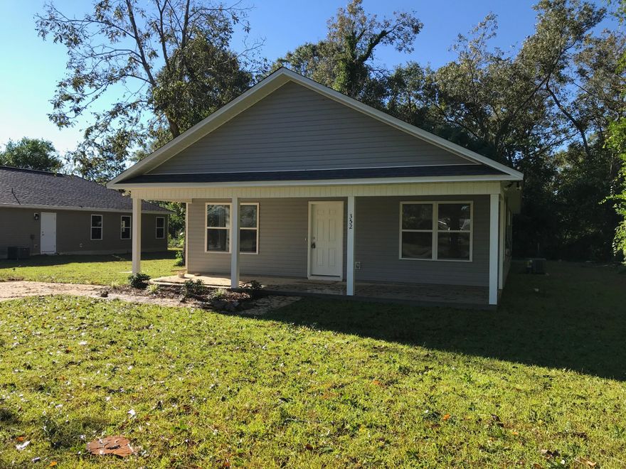 A welcoming covered front porch greets you as you approach this newly constructed home. This home features and open floor plan with 3 bedrooms and 2 baths. The large living room is open to the kitchen and dining room making the space feel even more spacious. The master bedroom features a walk in closet and dual sinks. Each bedroom features a nice sized closet. The covered rear porch and back yard are shaded by mature trees. This new construction with antique charm is a rare find in an established neighborhood.