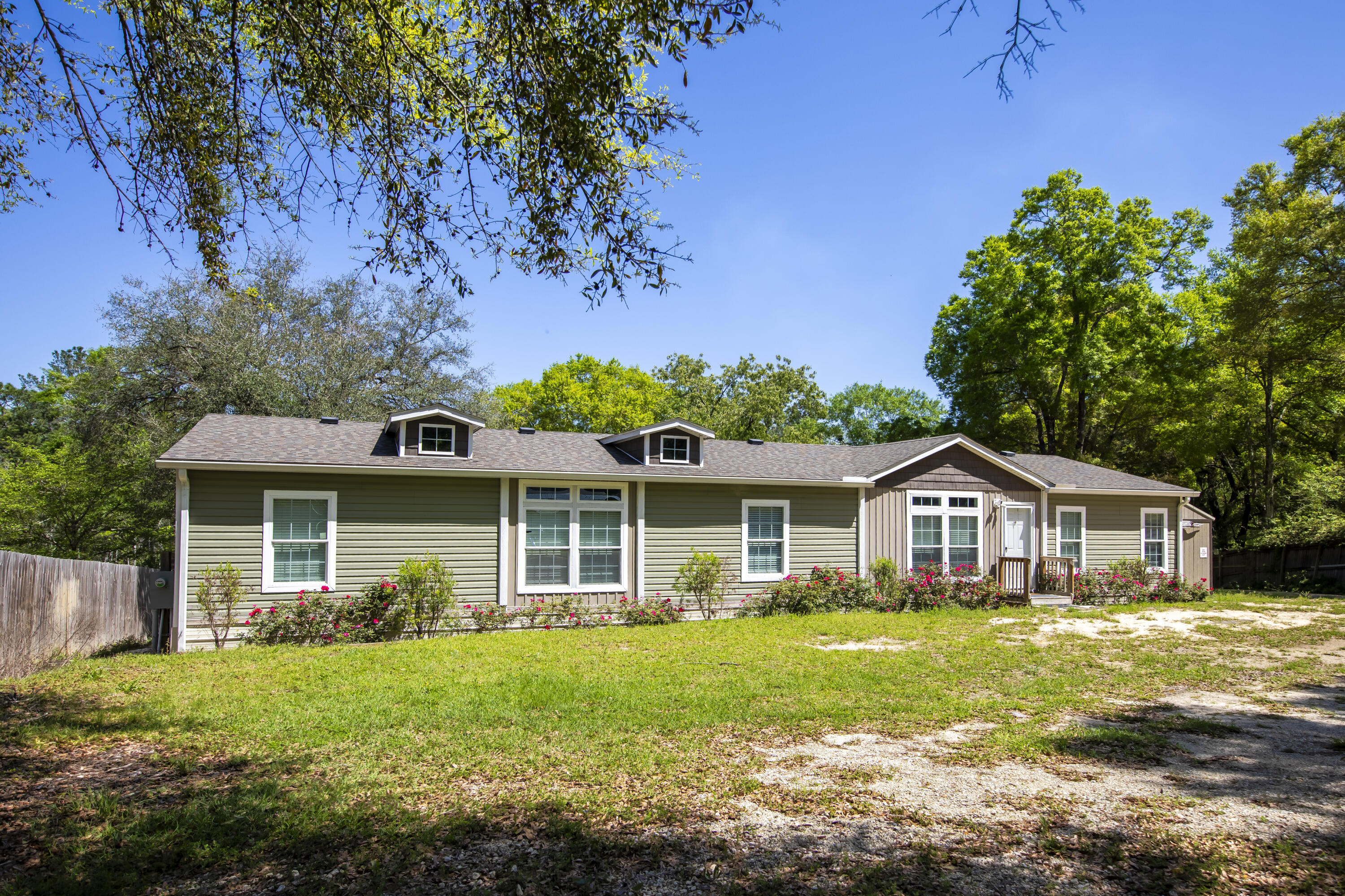 Looking for that perfect spot on Black Creek??? This beautiful 4 bedroom 2 bath mobile home sits on two lots and has approximately 210' of water frontage! Home has a formal living room as well as a great room with a beautiful entertainment center and fireplace. Kitchen has all stainless steel appliances, granite countertops, stainless steel farmhouse sink, and barn door for the pantry. Property has a 50 amp service for RV, partial seawall, dock, and storage building as well as a privacy fence on the front and sides of property. Call or text D'aun at (850) 333-1364 to see this great property! All measurements are approximate. Buyer to verify all dimensions. Property consists of 2 lots.