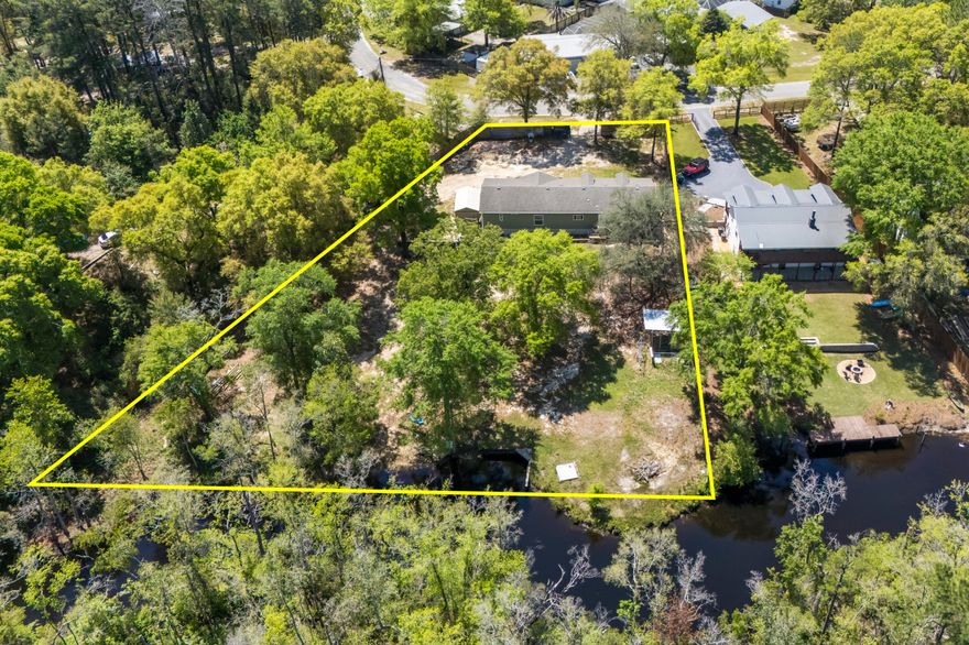 PRICE REDUCED + $5,000 BUYER CREDIT WITH ACCEPTABLE OFFER! Sportsman's paradise waterfront retreat with direct bay access. This spacious home is situated on two oversized lots offering approximately 210 feet of frontage along a peaceful creek with access to Choctawhatchee Bay. The interior features a formal living room and a large great room with an entertainment center and fireplace, ideal for entertaining. The kitchen is well appointed with stainless steel appliances, granite countertops, a stainless farmhouse sink, and a barn-door pantry. Exterior amenities include a partial seawall, private dock, storage building, 50-amp RV service, and privacy fencing along the front and sides of the property. A rare opportunity to enjoy waterfront living with added buyer incentive. Buyer to verify all approximate measurements. Call D'aun Carter at (850) 333-1364 to schedule your showing today!