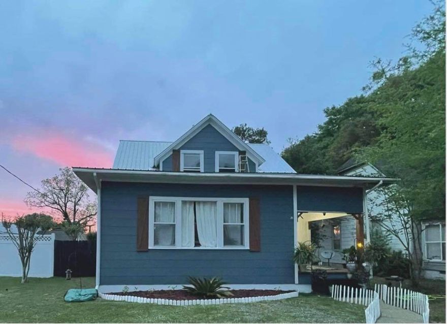 Check out this charming home located just steps from Lake DeFuniak. This home has many updates but still has that Historic feel when entering the home. Beautiful, original pine floors, large master-suite with updated bathroom with clawfoot tub. The kitchen is very large with lots of cabinet space, farmhouse sink, butcher block counter tops, subway tile back splash and sliding barn door entering the laundry room. Upstairs there are two over-sized bedrooms with a full bath. The back yard is fenced with a work-shop and bathroom. Schedule your tour today!