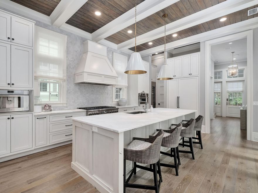 Situated in WaterColor's coveted Lake District, this exceptional 6-bedroom, 8-bathroom residence defines coastal luxury at its highest level. Professionally designed and offered fully furnished, the home delivers an effortless blend of sophistication, comfort, and investment appeal. With $369,641 in rental revenue for 2024 and $344,131 already secured for 2025, it serves equally well as a premier personal retreat or a high-performing rental asset. The open, airy floor plan was designed for both gathering and unwinding. A gourmet kitchen anchors the main level with premium appliances, an oversized island, and custom cabinetry. It flows seamlessly into the dining area and great room, where a fireplace, coffered ceilings, and refined designer finishes create a warm yet elevated atmosphere. Expansive glass doors dissolve the boundary between indoors and out, revealing a private outdoor sanctuary with a heated pool and hot tub, covered patio, and a fully equipped summer kitchen ideal for year-round entertaining.

All six bedrooms feature ensuite baths, offering comfort and privacy for guests and family members. The second level hosts a serene primary suite with a spa-inspired bath, private balcony, and spacious walk-in closet. This floor also includes an additional guest suite, a relaxed lounge area, and separate guest quarters complete with a kitchenette, bath, and laundryperfect for extended visits.

Accessible by stairs or elevator, the third level offers a charming bunk room, an additional sitting area, and extra sleeping accommodations, providing generous space for larger groups. Throughout the home, thoughtful craftsmanshipcustom millwork, designer lighting, and curated finisheselevates every detail.

Ideally positioned near the WaterColor Beach Club, Camp WaterColor, scenic trails, and the dining and boutique shopping along 30A, this home delivers an unparalleled lifestyle in one of the Emerald Coast's most sought-after communities. Whether envisioned as a full-time residence, a refined coastal getaway, or a proven investment property, it stands as a true masterpiece of design and livability.