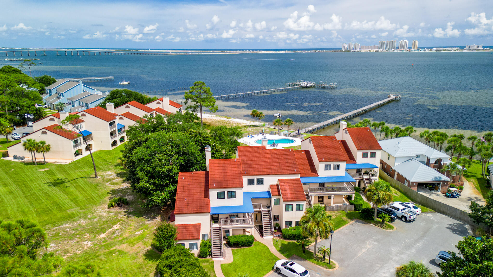 Imagine waking up to breathtaking sunrises and unwinding with stunning sunsets in your inviting 3-bed, 3-bath condo at Safe Harbour Village. This coastal gem is perfect for entertaining or unwinding and offers ground floor access. Savor beautiful water views from your private patio on the ground floor or your private balcony off the Master Bedroom on the second floor and take advantage of resort-style amenities including a swimming pool, private beach access, and a dock on the intracoastal. Embrace the Navarre lifestyle with pristine beaches, local dining, and endless outdoor activities just minutes away. Make every day a getaway in your Safe Harbour Village Condo.